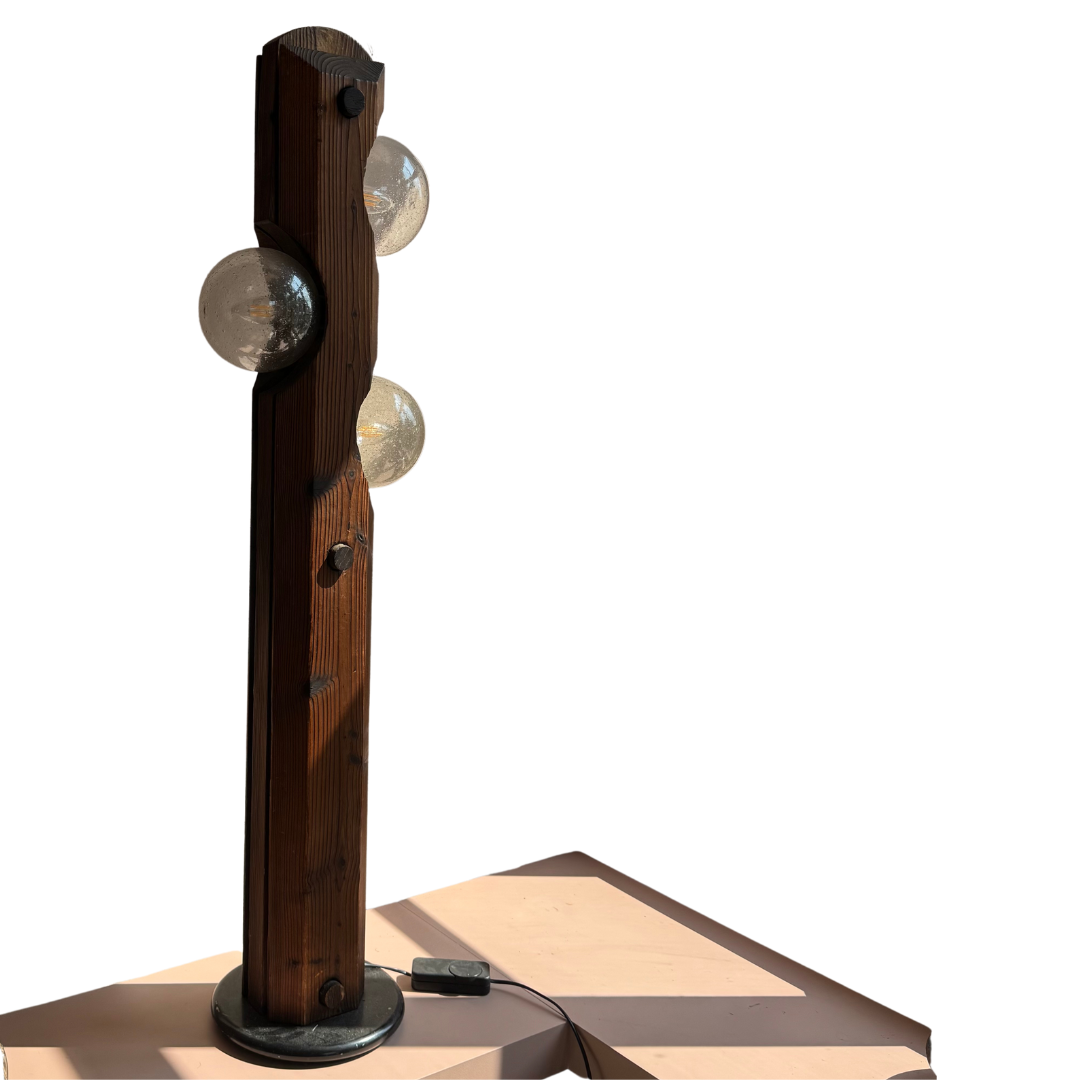 Brutalist Swiss floor lamp with embedded glass globes in sculpted wood beam.