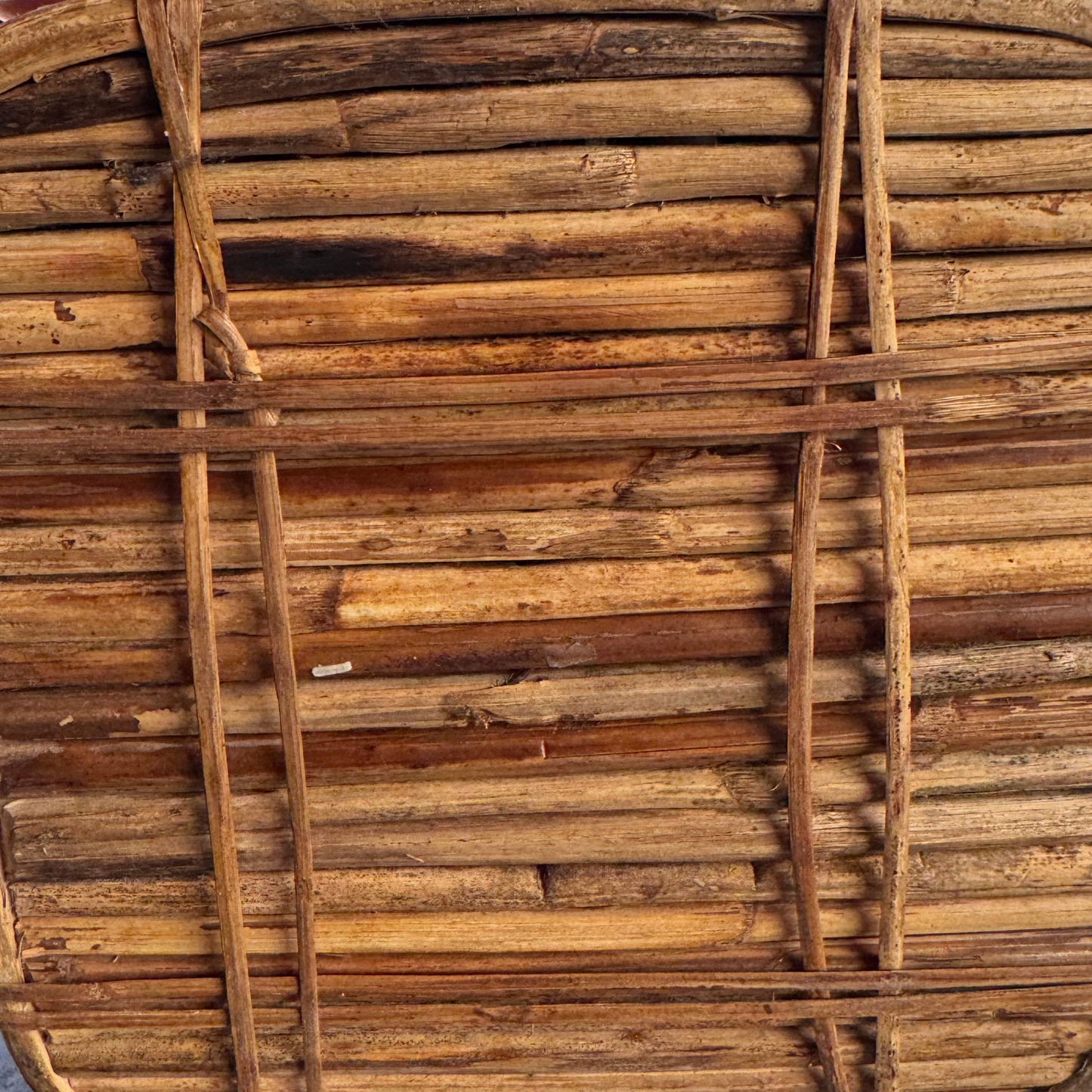 Underside view showing rattan base construction and maker markings