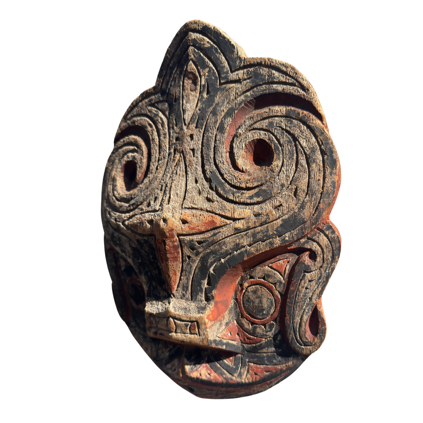 Front view of a carved Toba Batak Singa protective panel with red, black, and white pigment.
