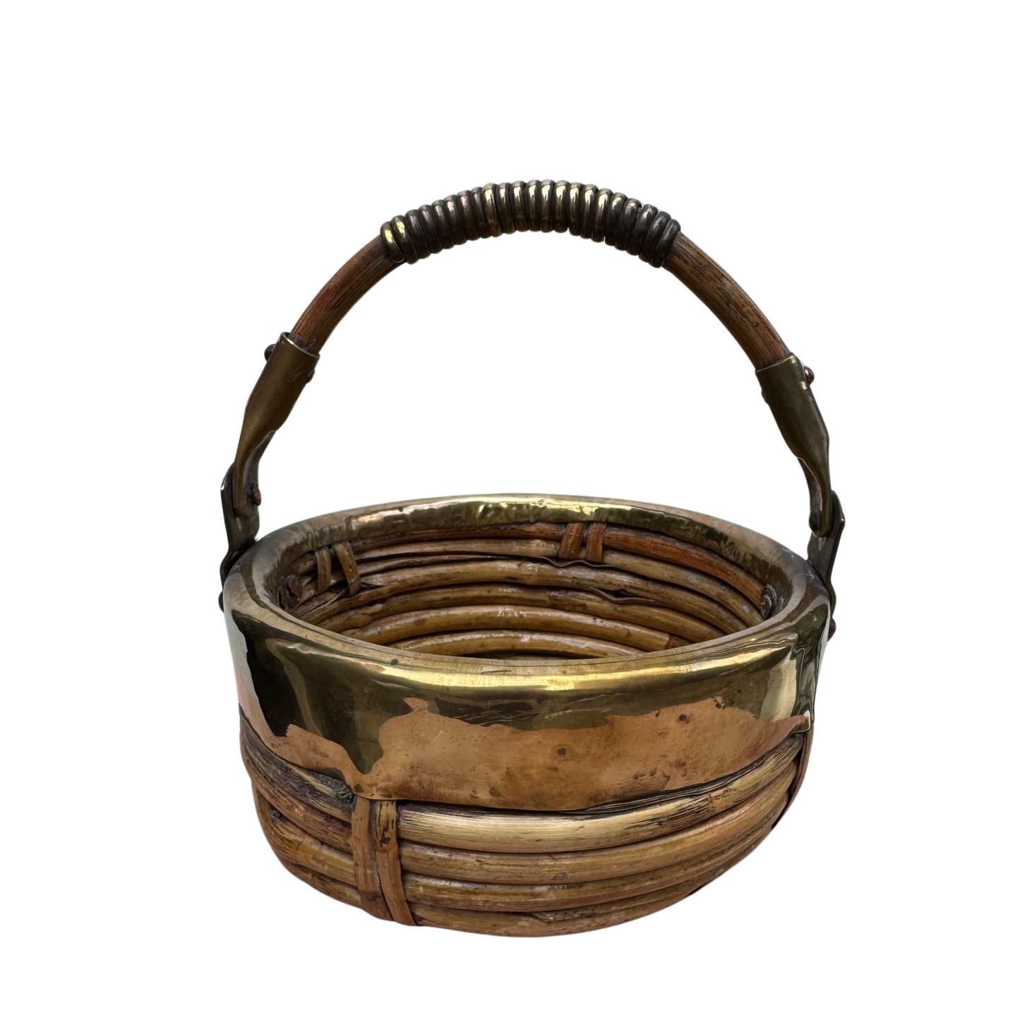 Front view of small round rattan basket with brass rim and curved handle