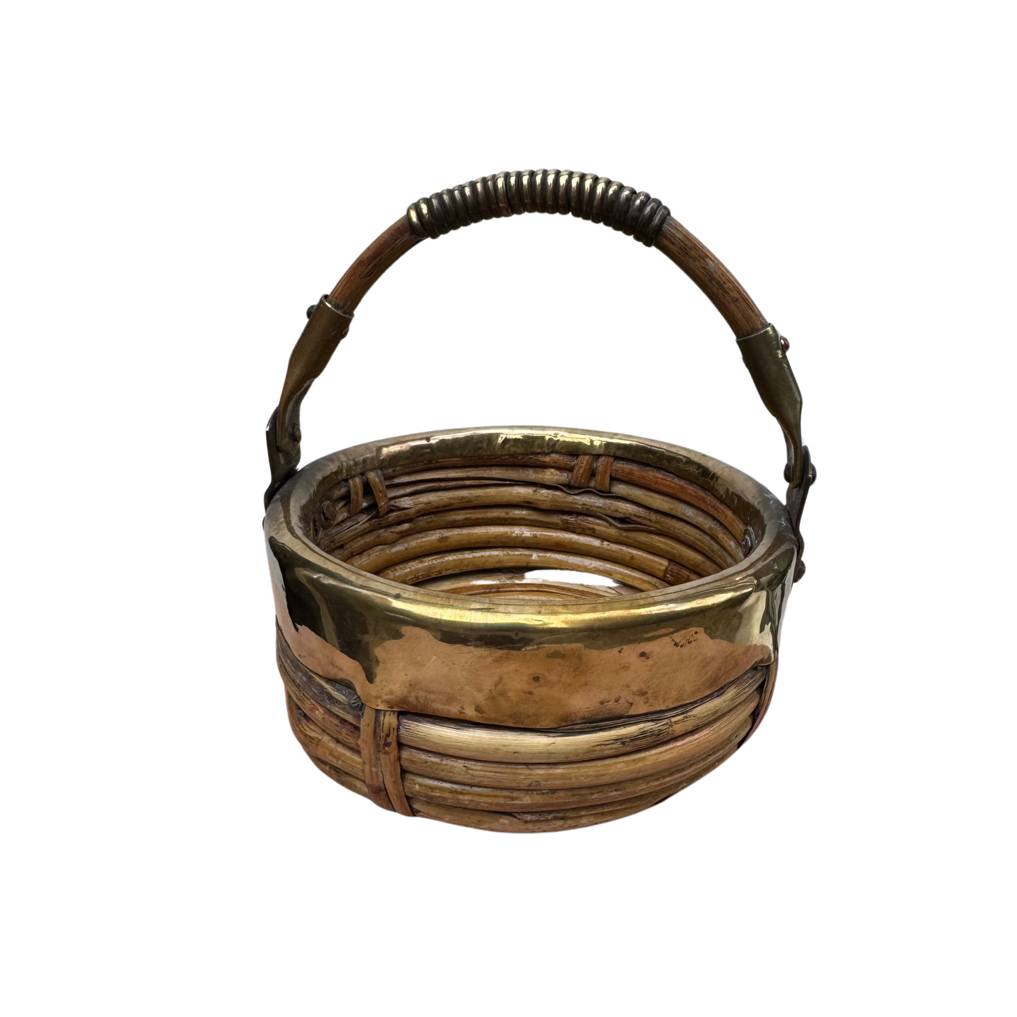 Side profile of round handwoven rattan basket with brass-wrapped handle