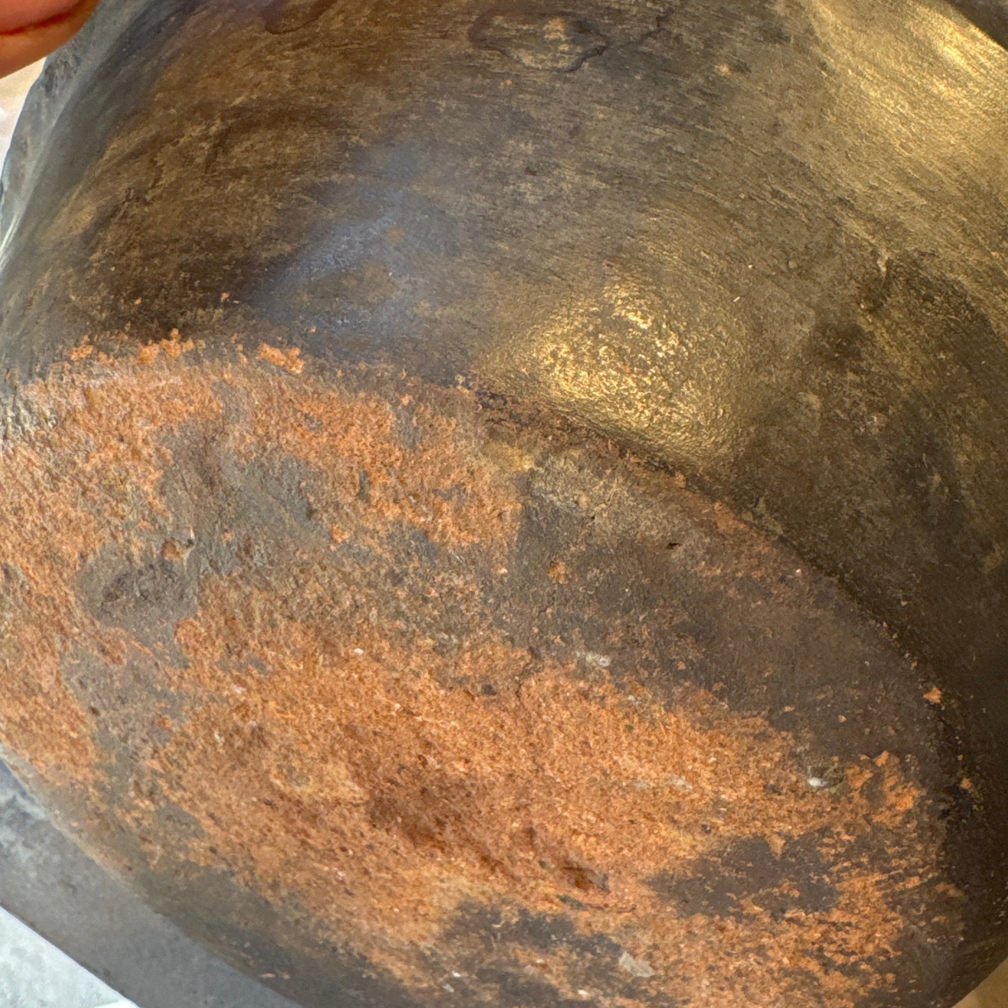 Underside of jug showing smoke and ash patina from traditional firing