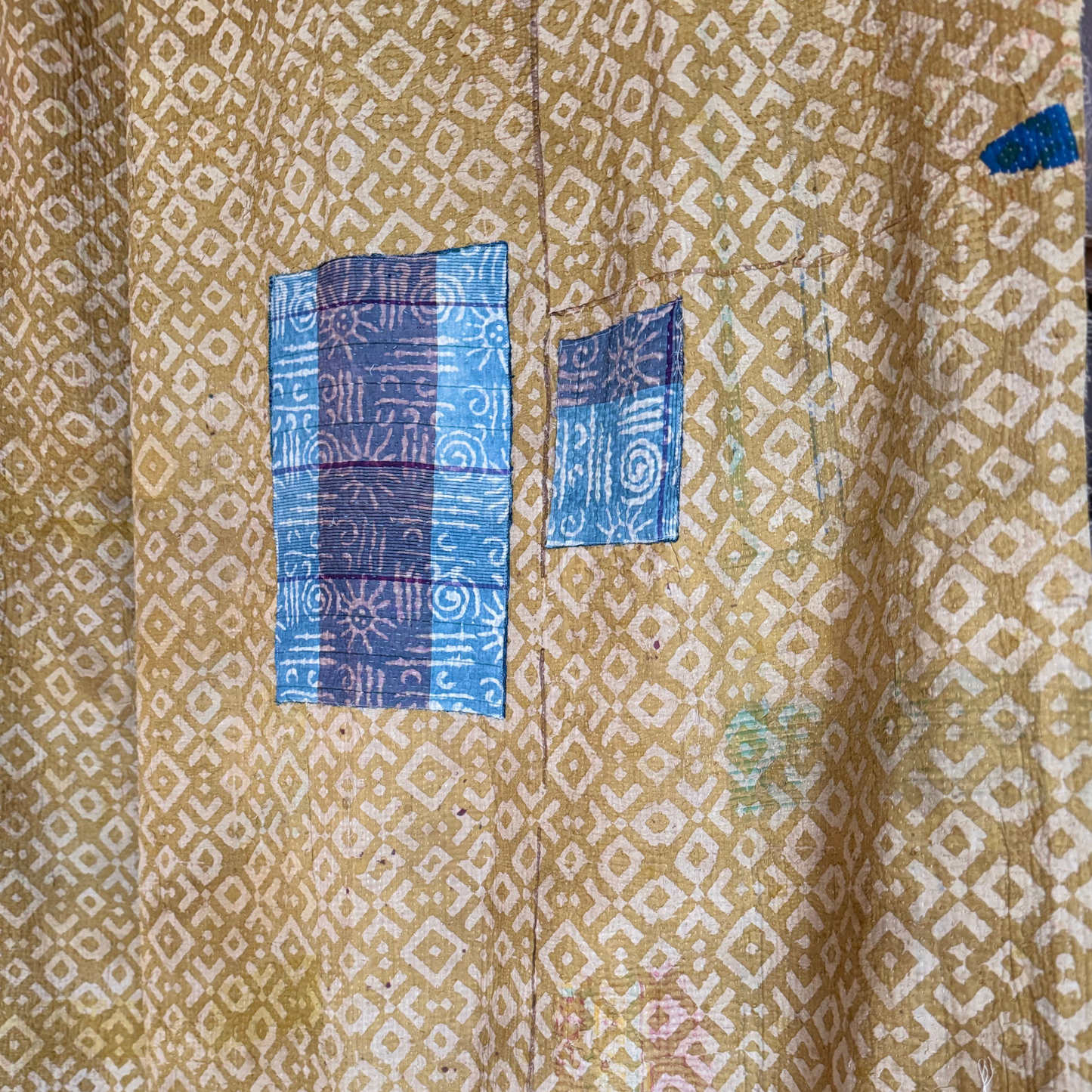 Detail of kantha front with resist print, patchwork stitching and indigo patterned fabric