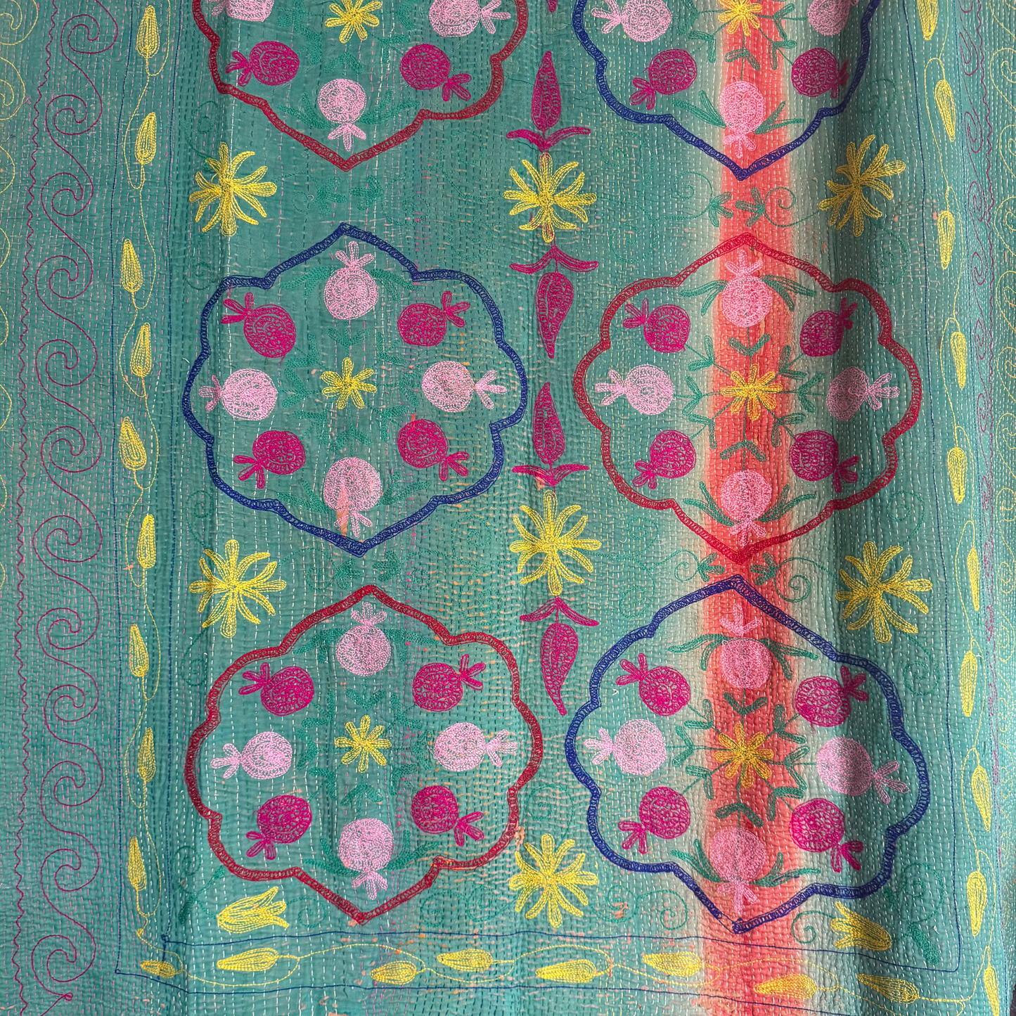 Detail of sunshine-yellow scalloped running-stitch border on cotton Kantha quilt