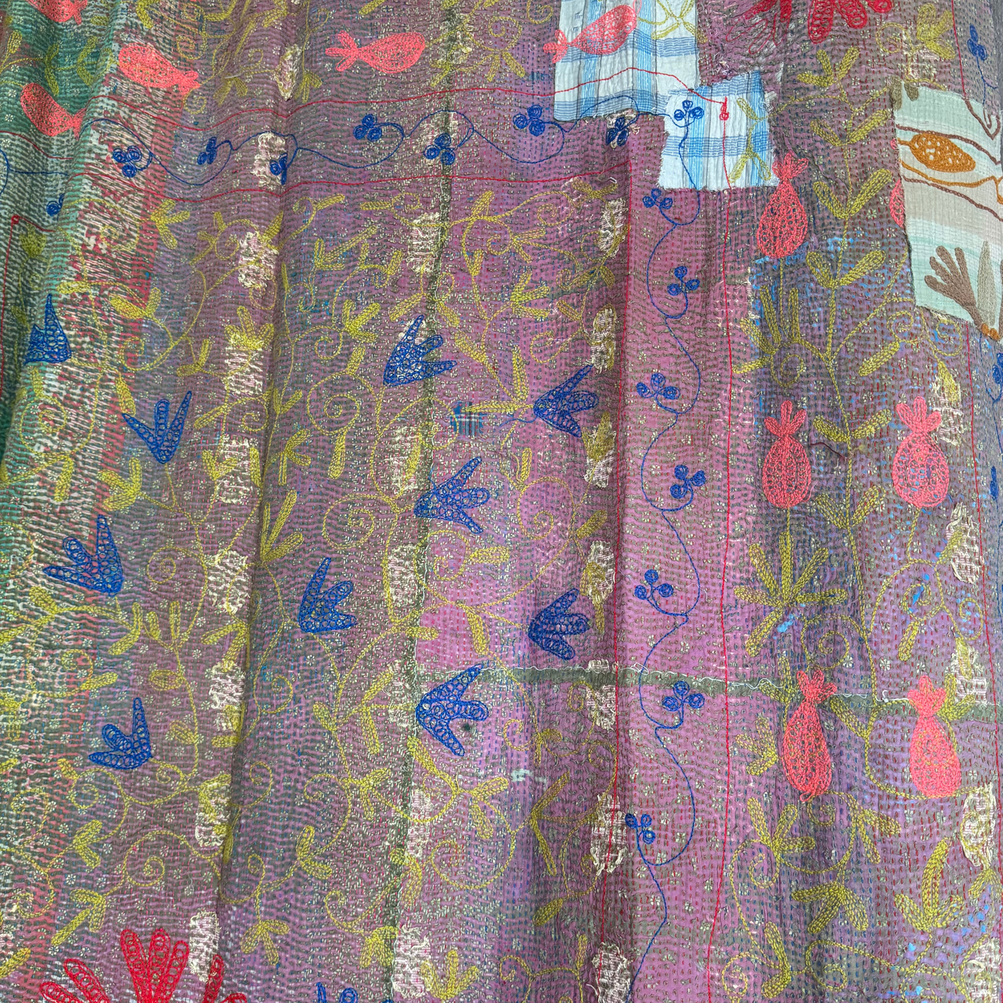 Back view detail of cobalt-blue tulip embroidery on hand-stitched cotton Kantha blanket
