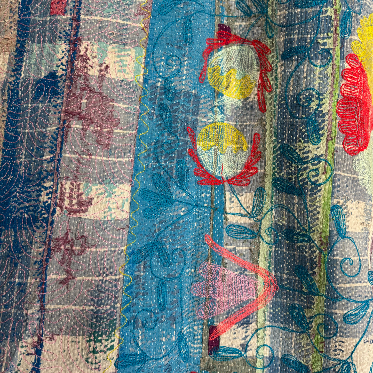 Close-up of wave-stitch accents and sari patchwork on reverse of cotton Kantha quilt throw