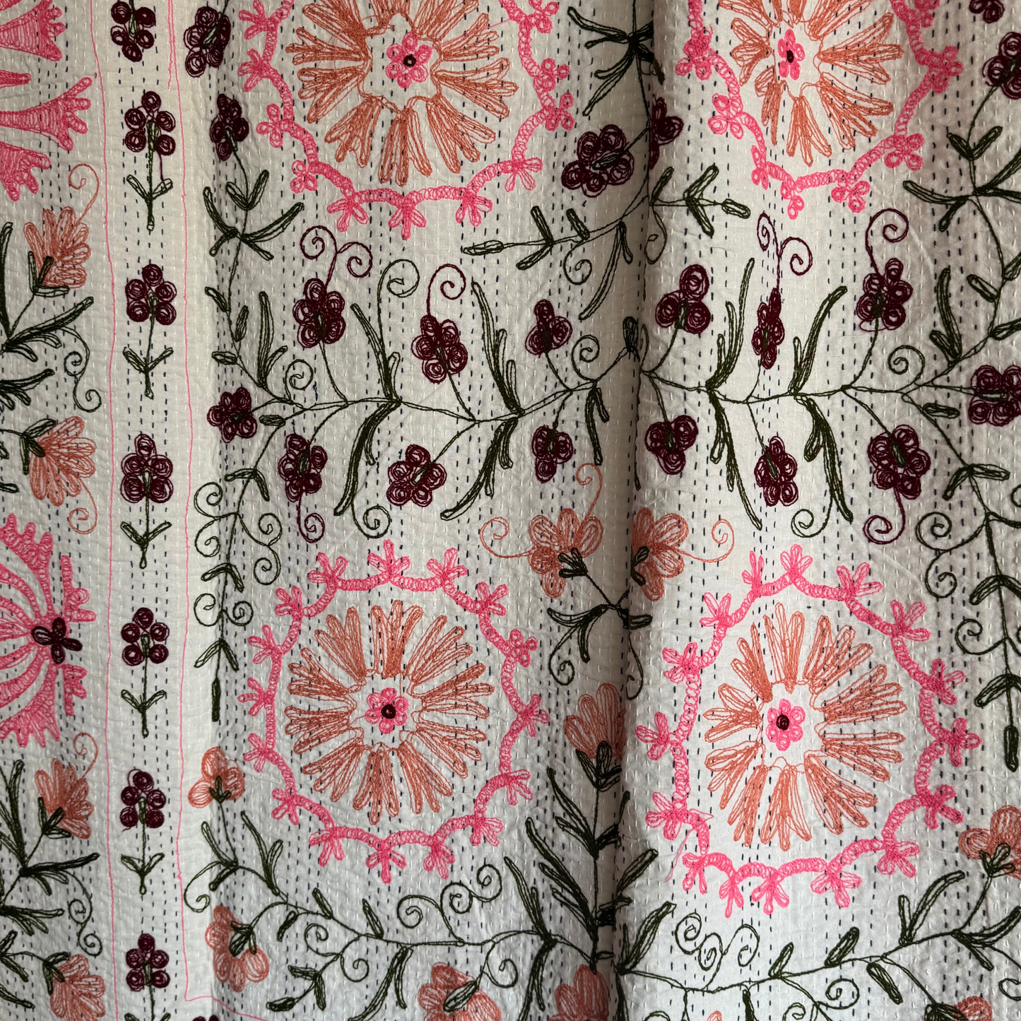 Kantha draped as a curtain, showcasing both embroidered front and stitched reverse
