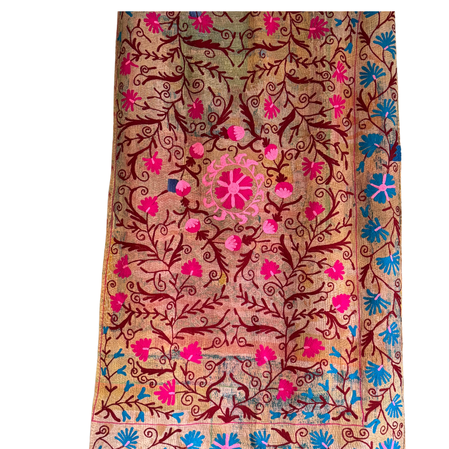 Kantha textile front view with pink floral vines and detailed center medallion on brown patchwork cotton