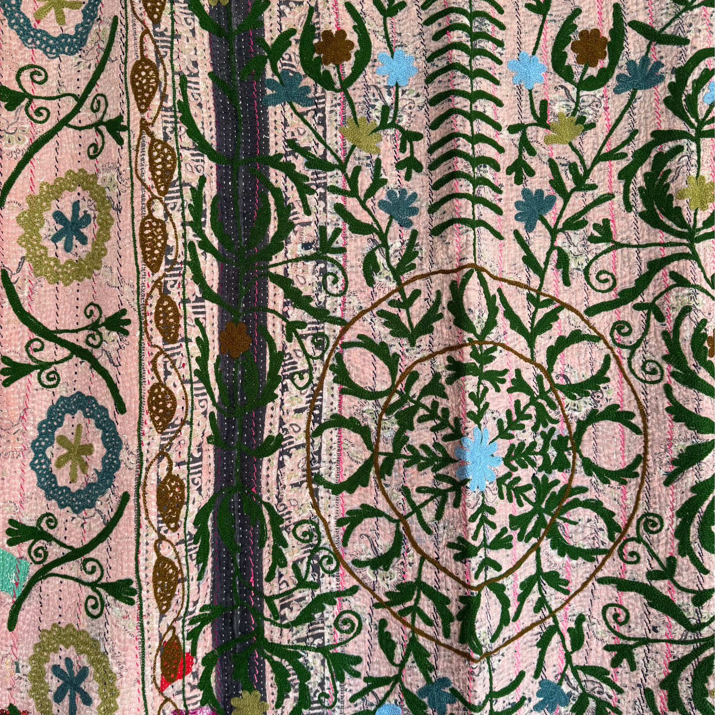 Embroidered circular floral medallion with vine patterns and fine stitching