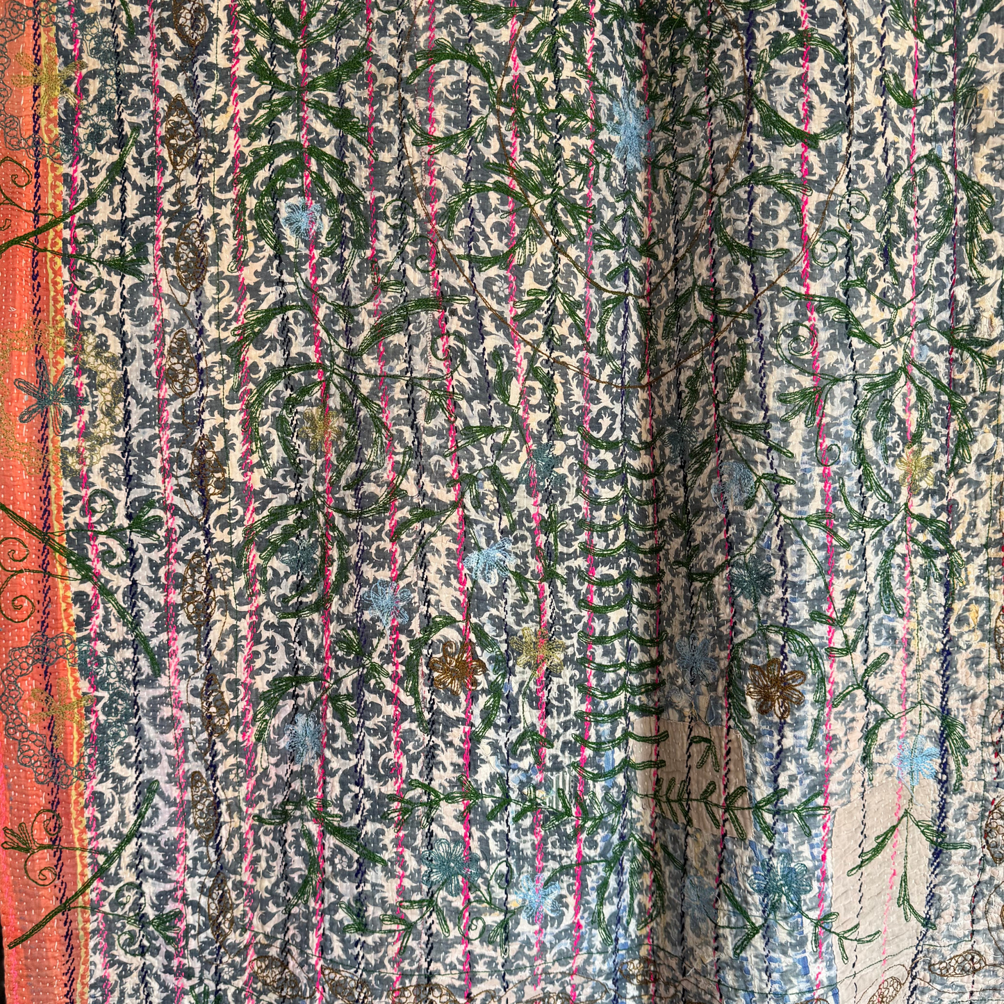 Full view of kantha reverse with dark floral pattern, embroidery, and subtle sari patching