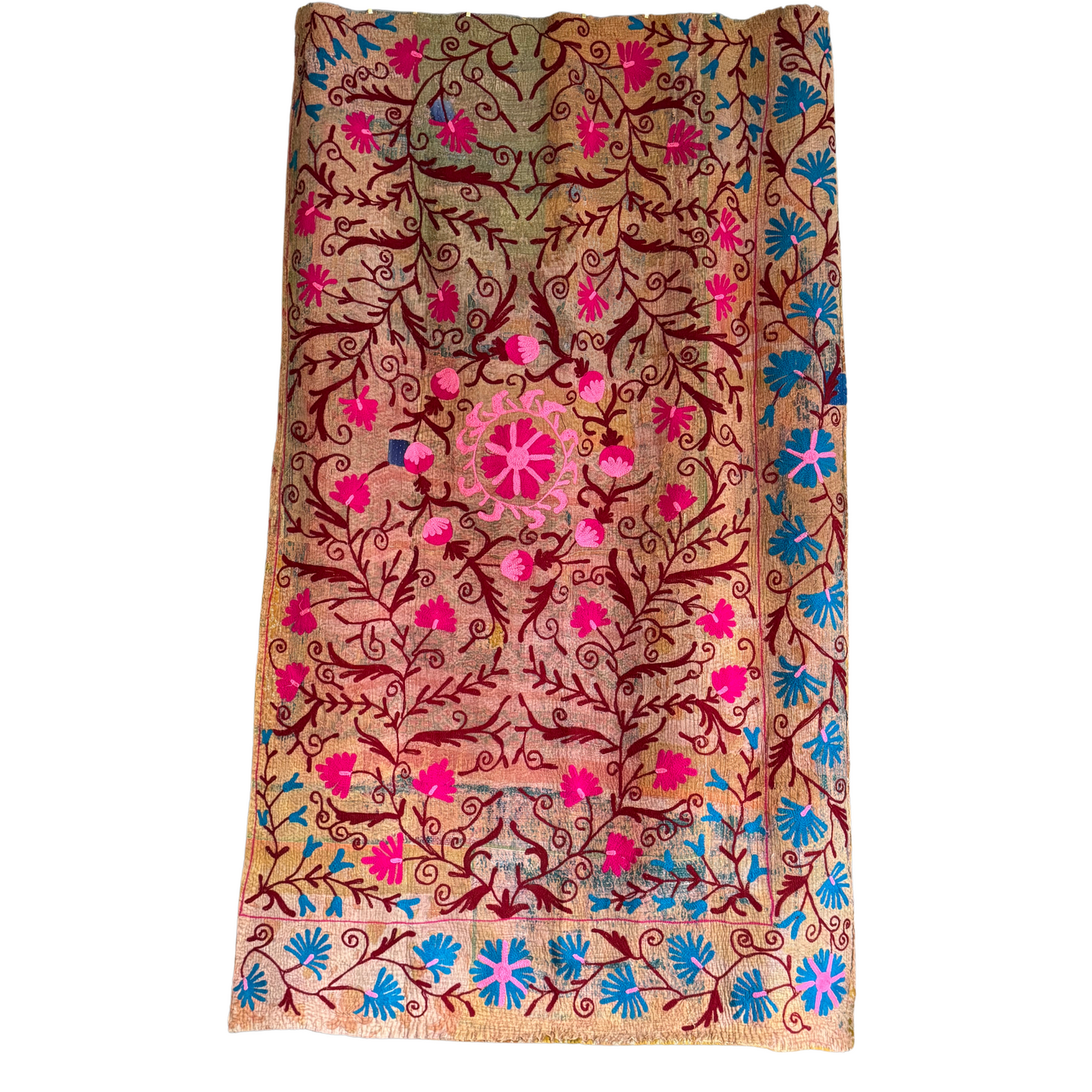 Full view of hand-stitched kantha with heavy cotton base, embroidered with fuchsia and blue florals on warm earth tones