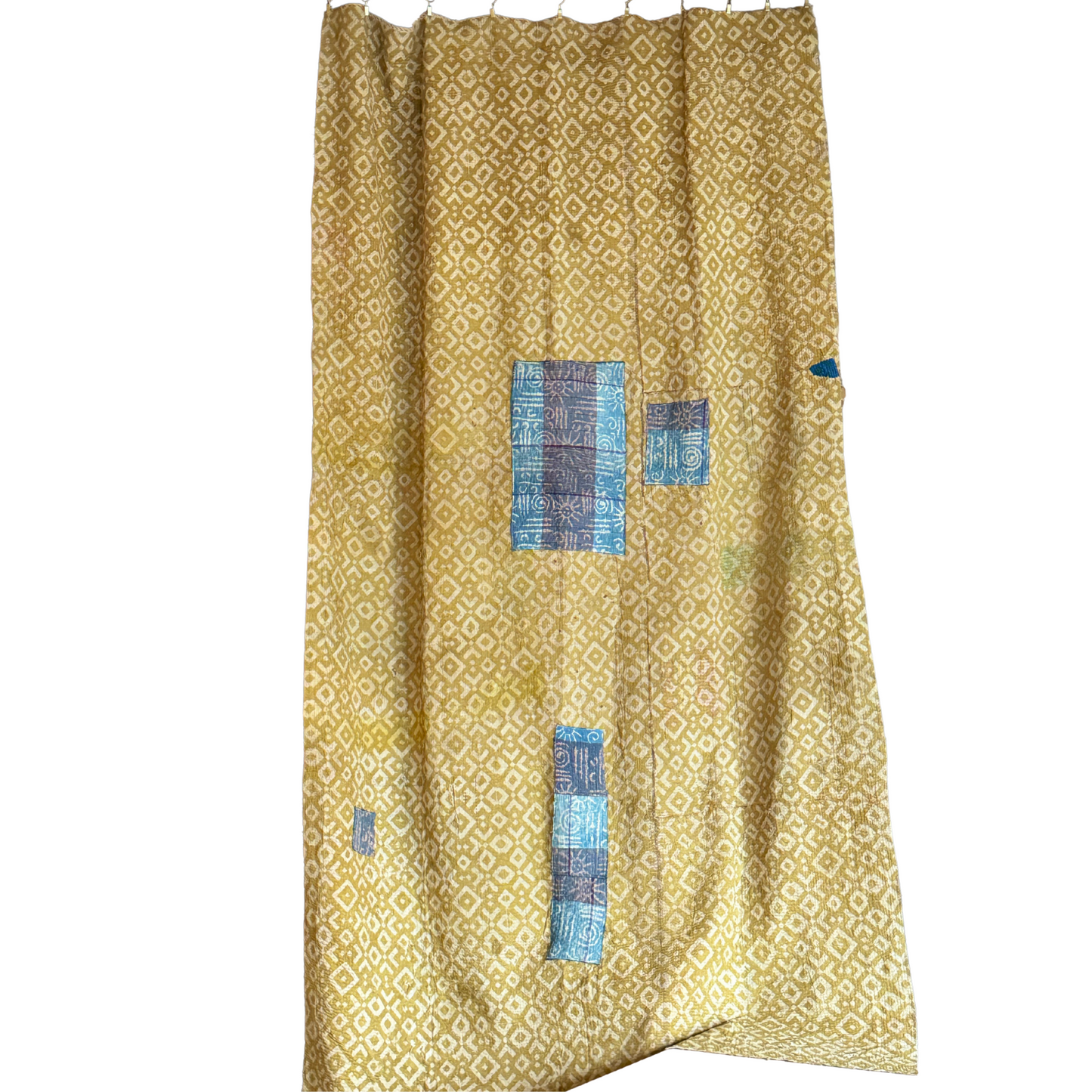 Full view of hand-stitched kantha in mustard with geometric print and indigo blue patch details