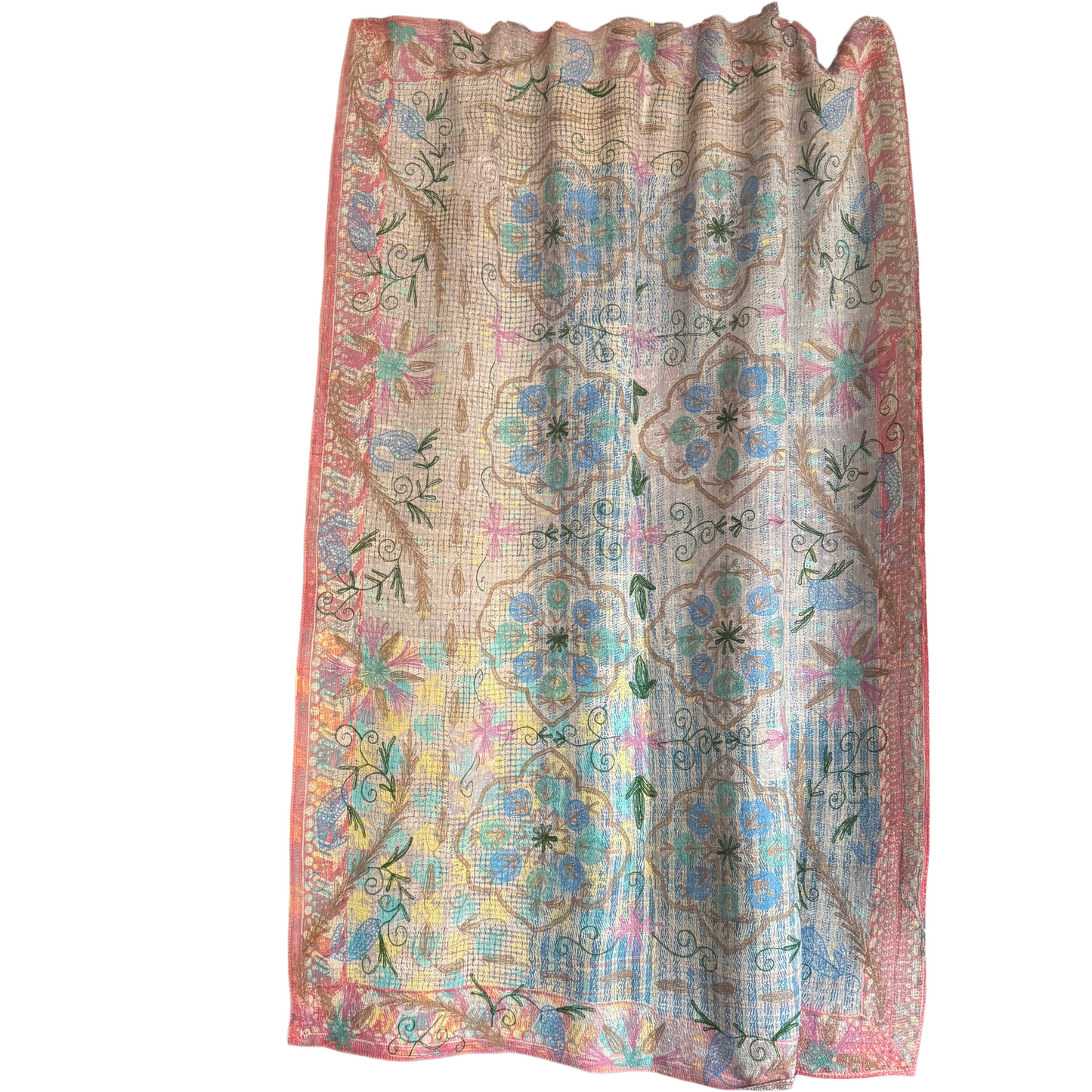 Kantha lightly draped as a curtain in front of a window, showcasing its translucent pastel layers and hand-stitched detail
