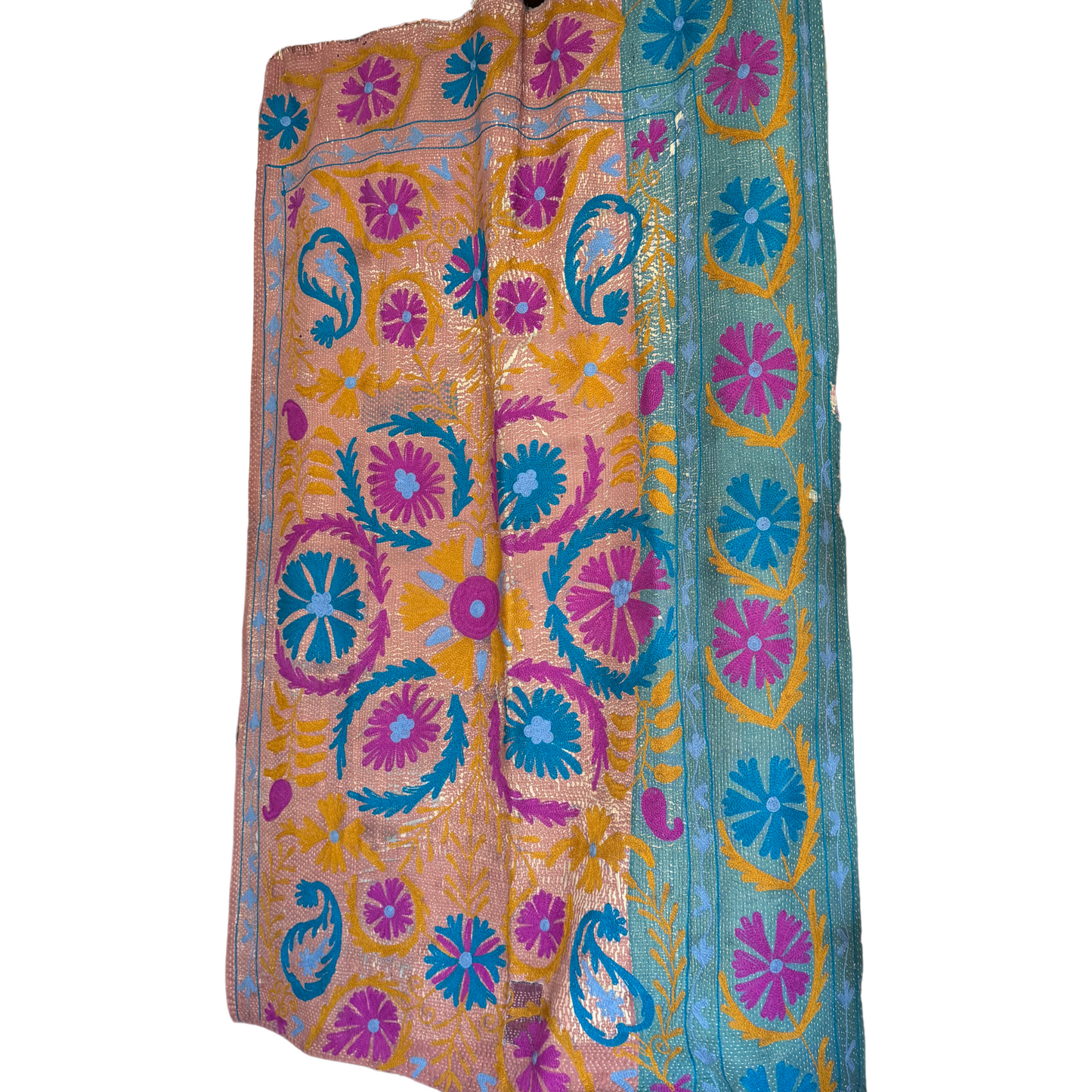 Close-up of hand-stitched paisley and petal motifs in teal and olive on rosé ground