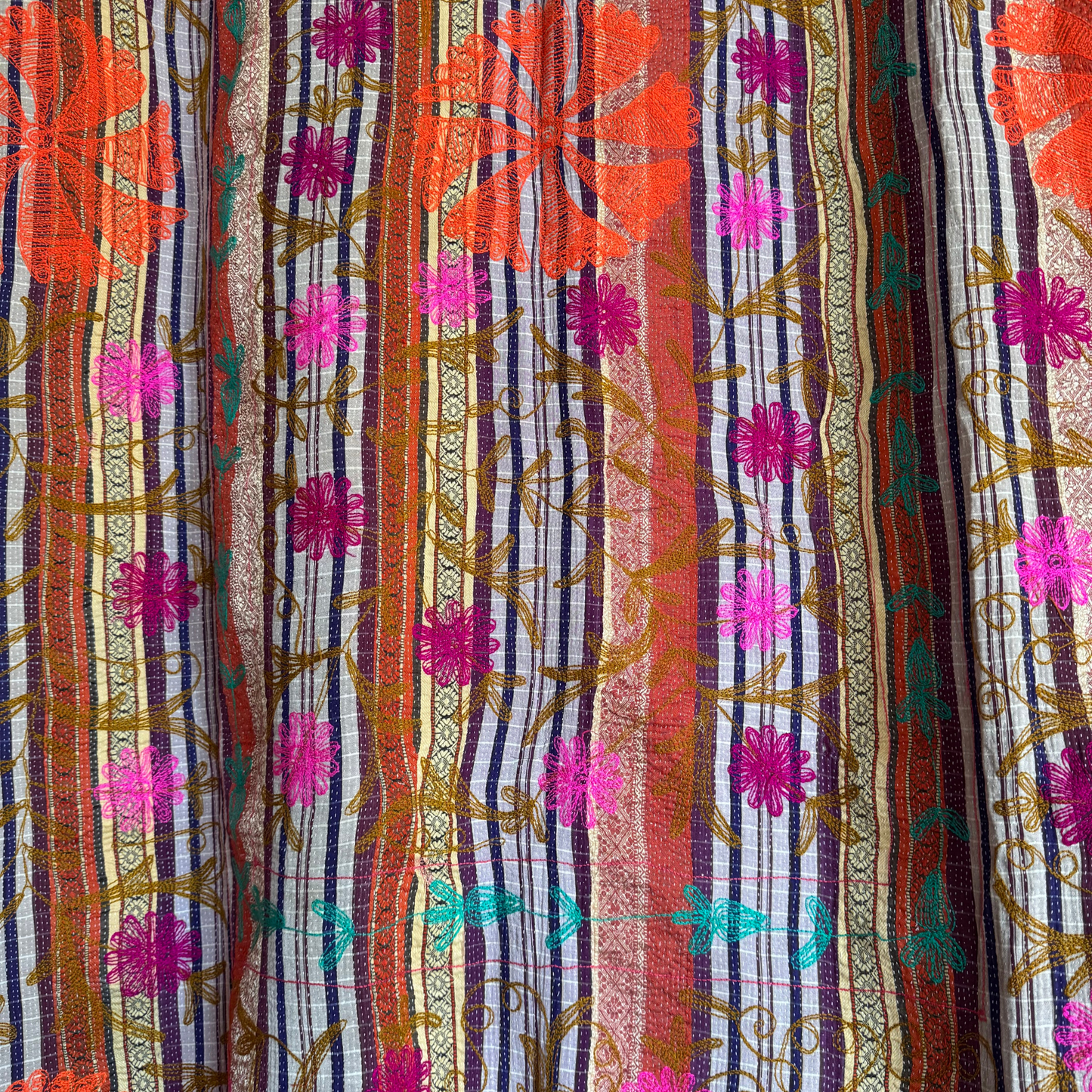 Close-up of sari-stripe weave with embroidered vine motifs