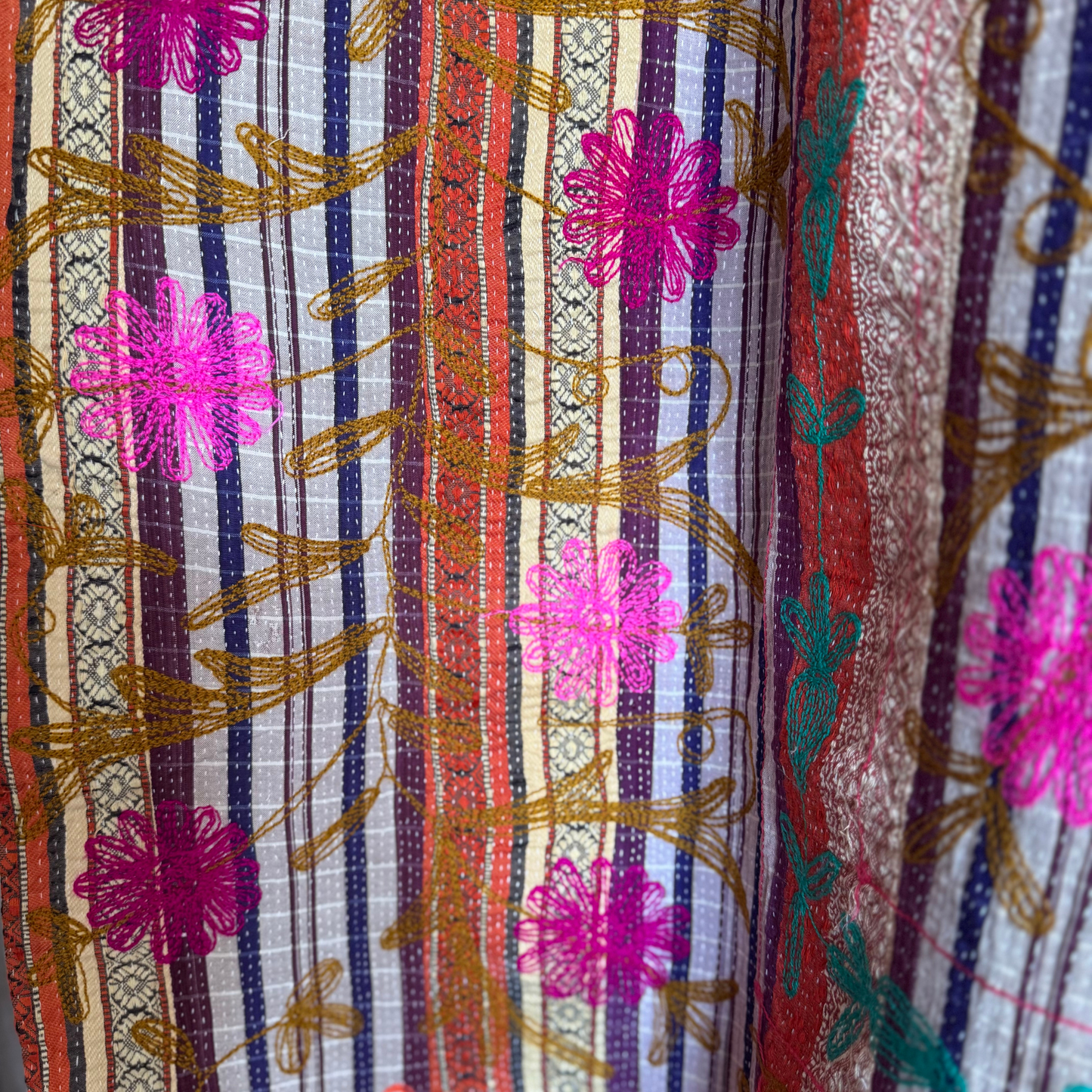 Detail of reverse stripe and colourful chain-stitch blossoms