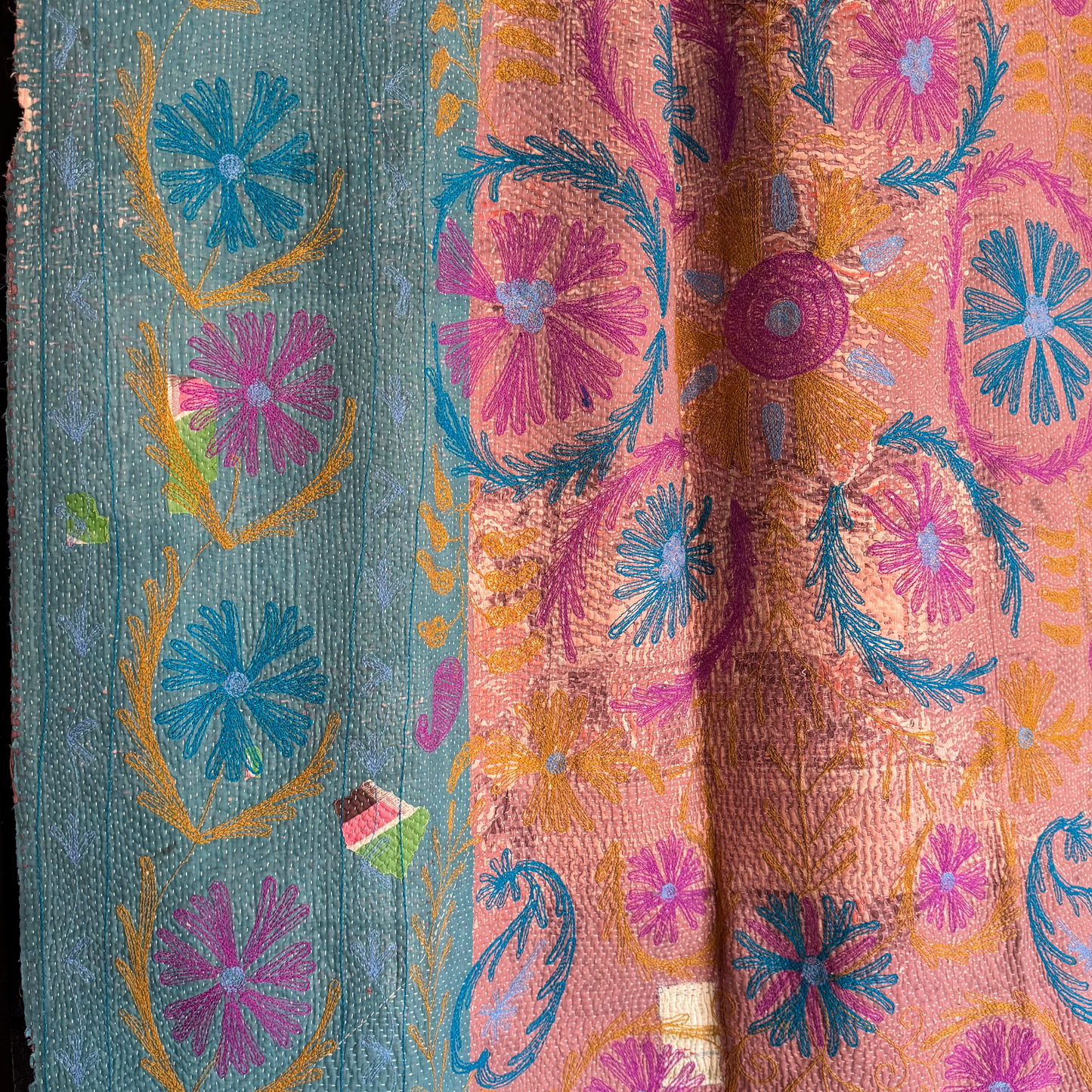 Full reverse view of kantha showing block-printed ground and stitched floral patterns