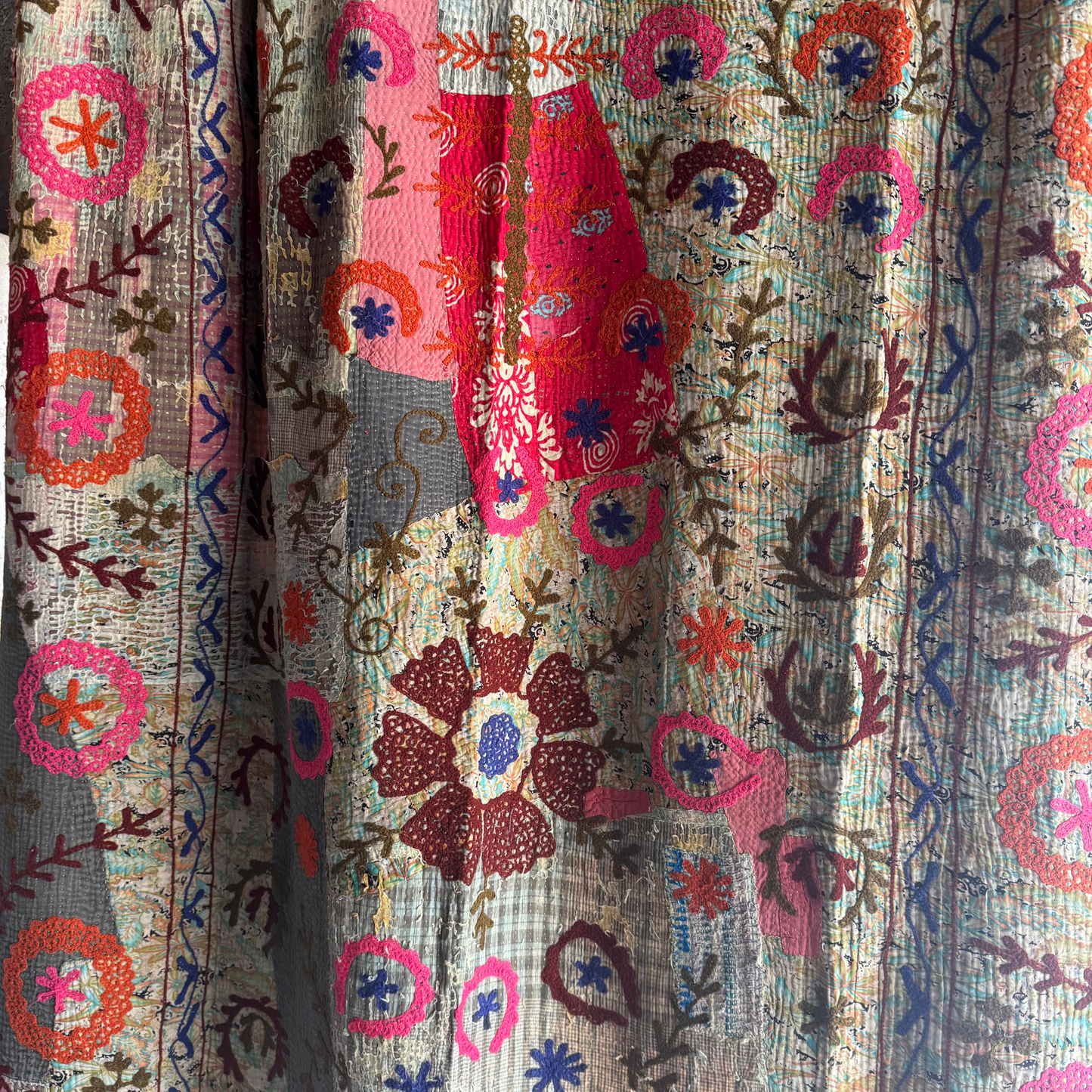 Close-up highlighting the dense running-stitch texture in brown thread