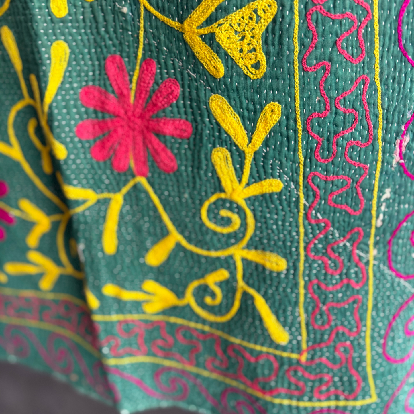 Close-up of dense running-stitch detail on front corner side