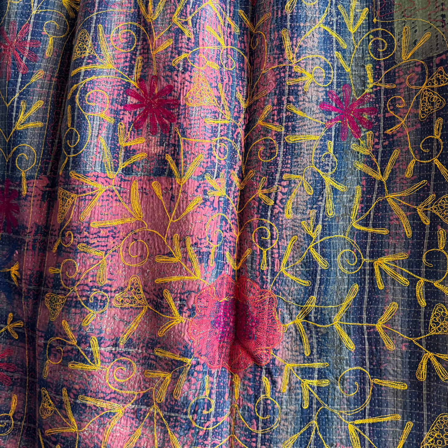 Close-up of dense running-stitch detail on the blue reverse side