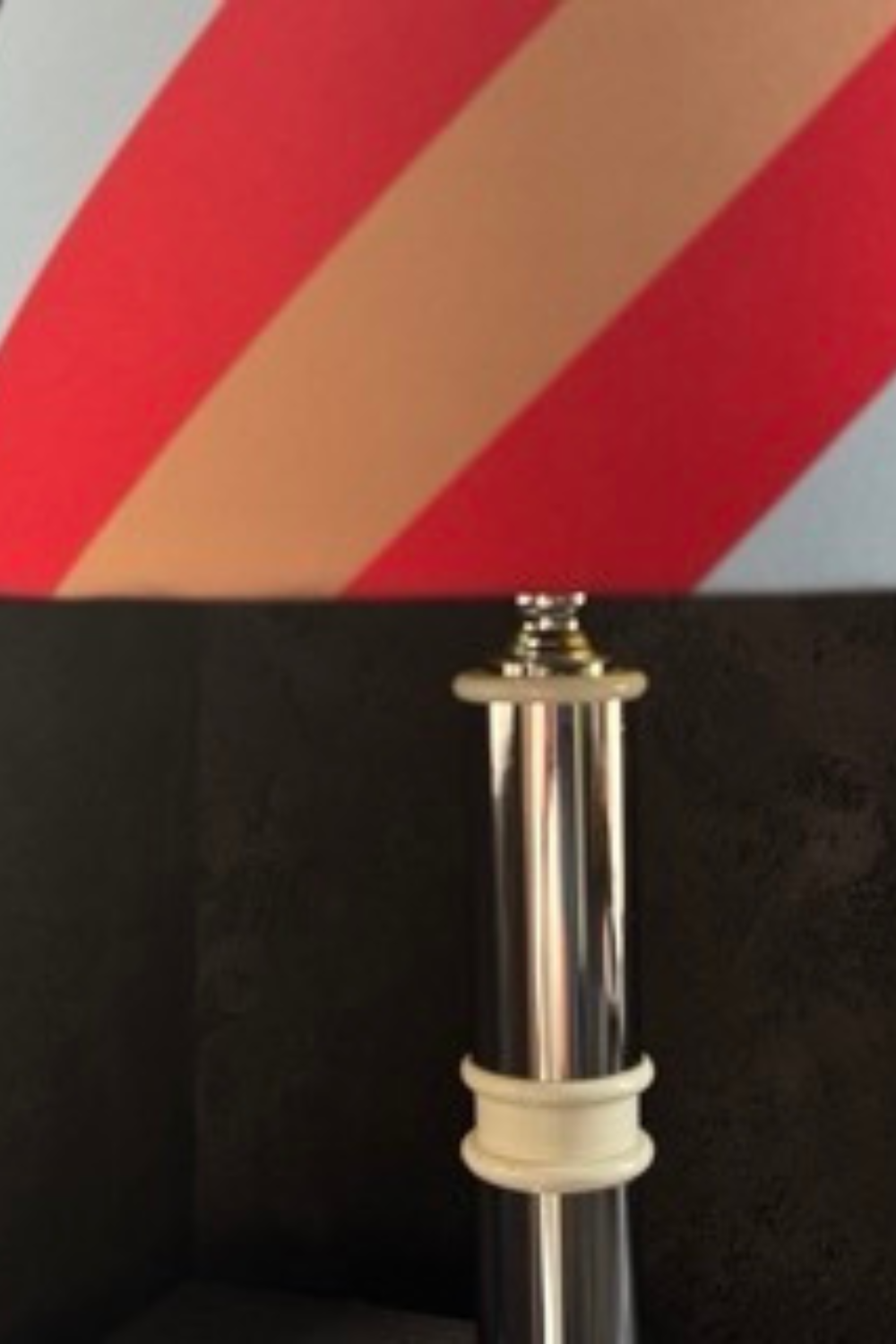 Close-up of the metal and white ceramic base of the mid-century style lamp, showcasing its clean lines and modern aesthetic.