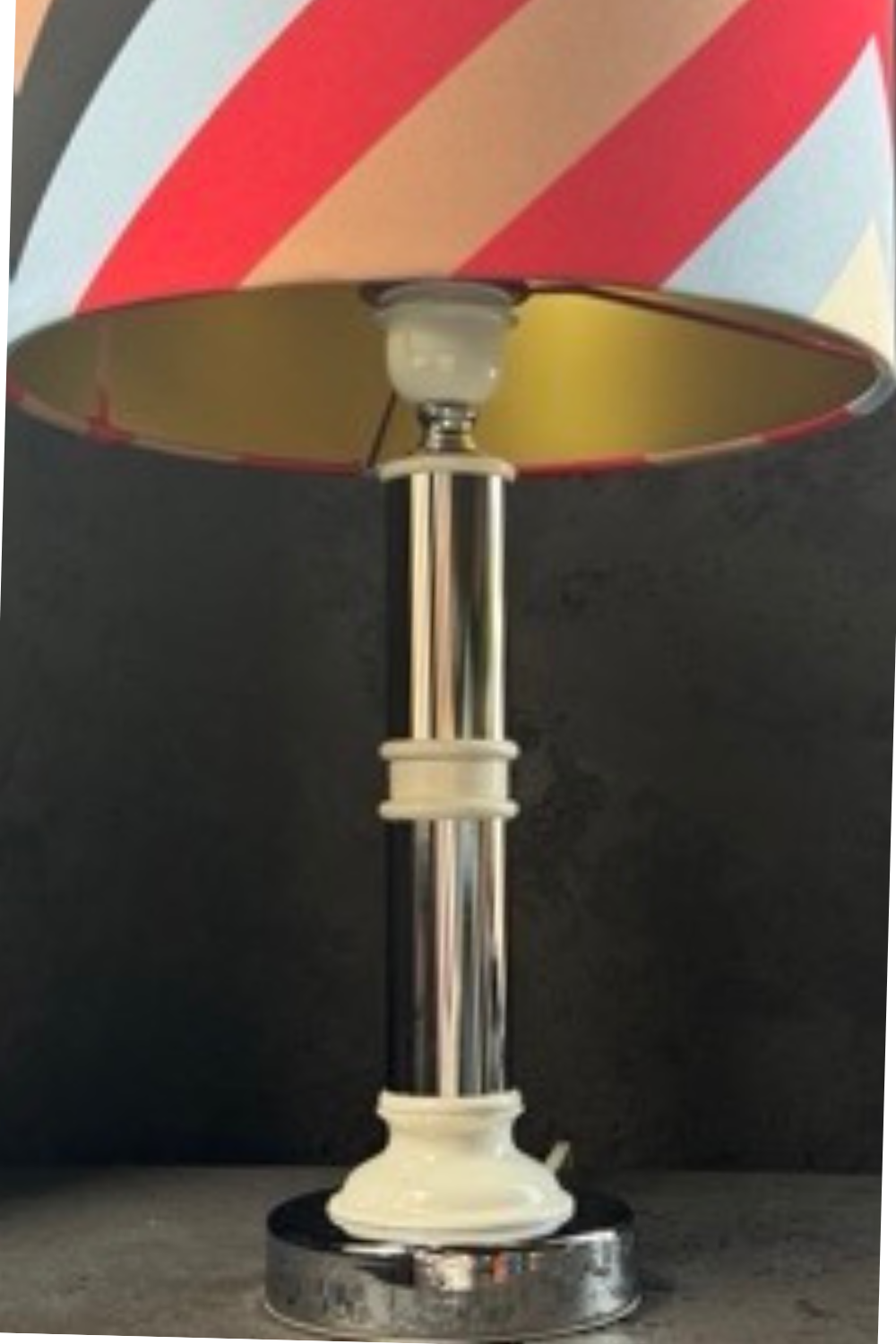 Side view of the mid-century style lamp with metal column and ceramic base, highlighting its sleek and elegant form.