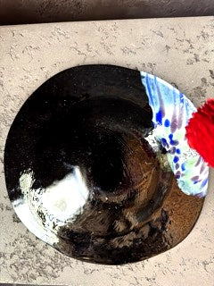 Side angle of a Murano glaze plate, showing its smooth curved shape, elegant finish, and artistic glasswork.