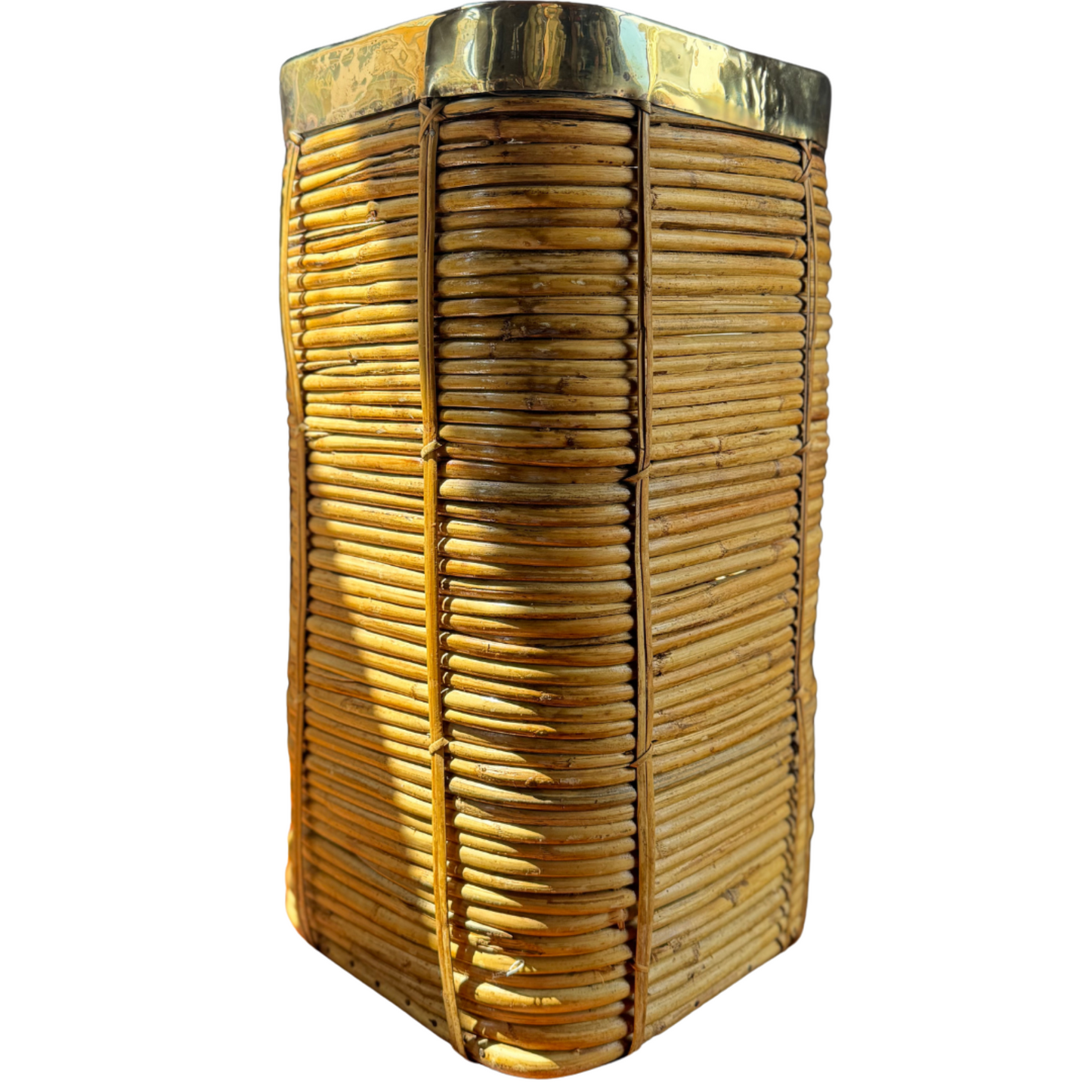 Front view of four-sided rattan planter with polished brass rim