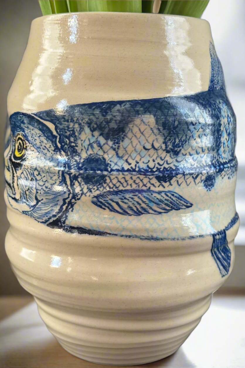 Close-up of the blue fish illustration on a handmade ceramic vase by QM Ceramics.