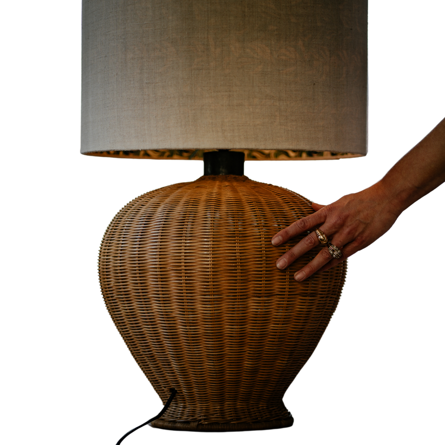 Side view of hand-woven rattan lamp base and inline cord switch