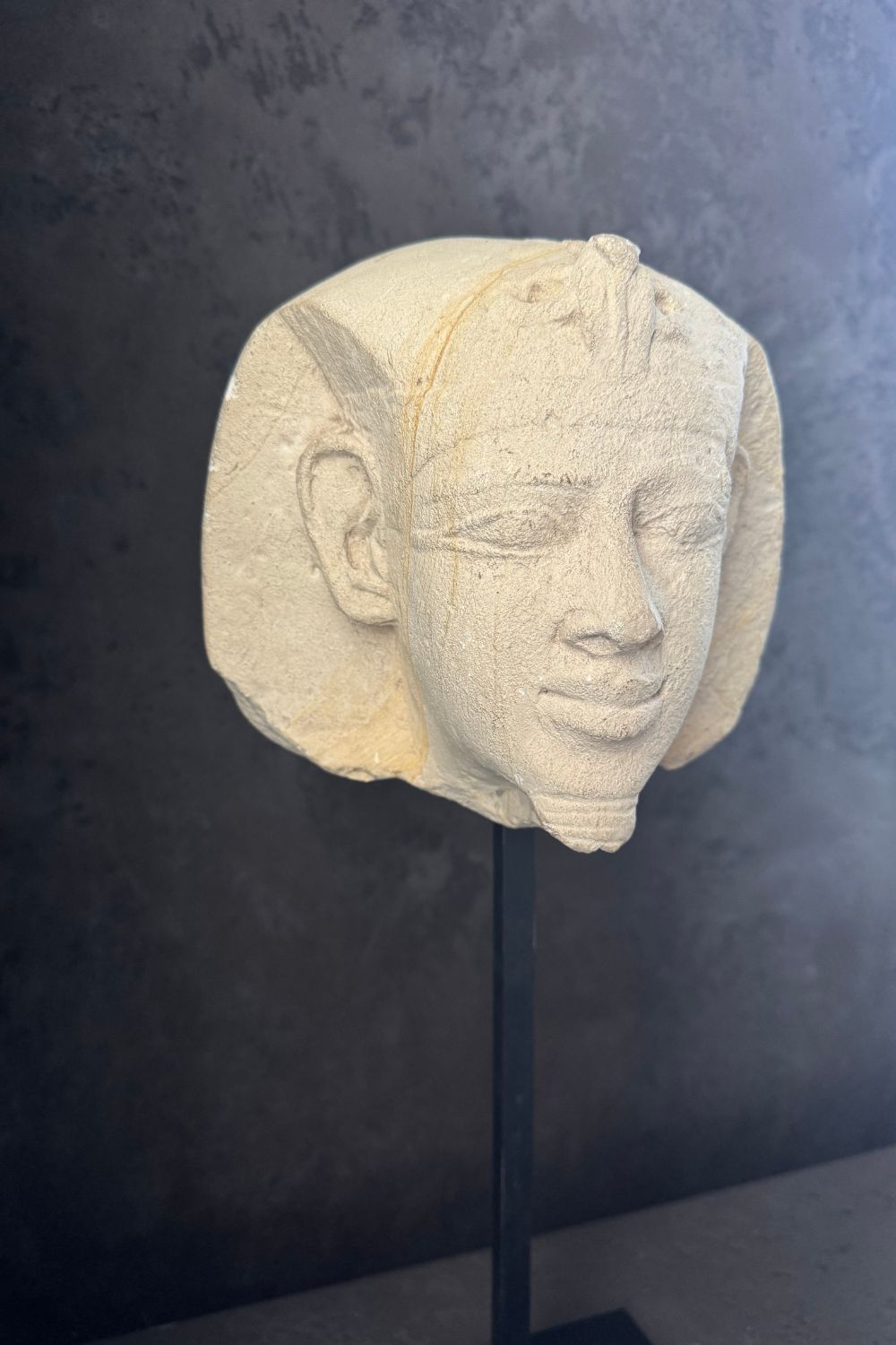 Final view of the stone pharaoh head sculpture, capturing the full piece from a different perspective.