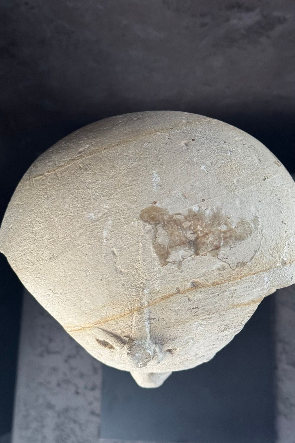 Top view of the stone pharaoh head sculpture, displaying the symmetry of the headdress and the fine stonework.