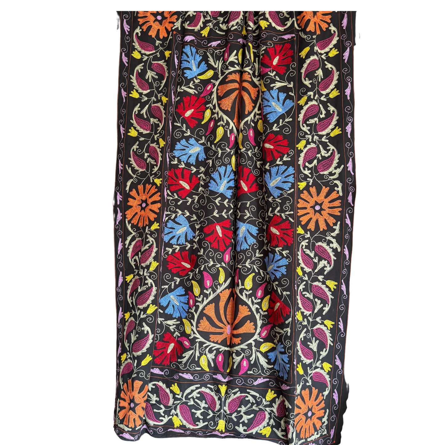 Reverse side of Suzani showing softer mirror-image embroidery tones