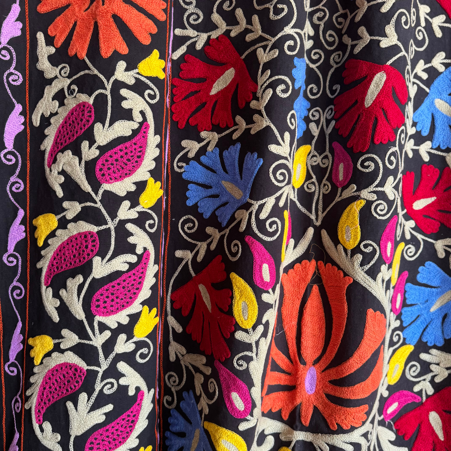 Vibrant orange and lemon-yellow floral motif in hand-stitched relief