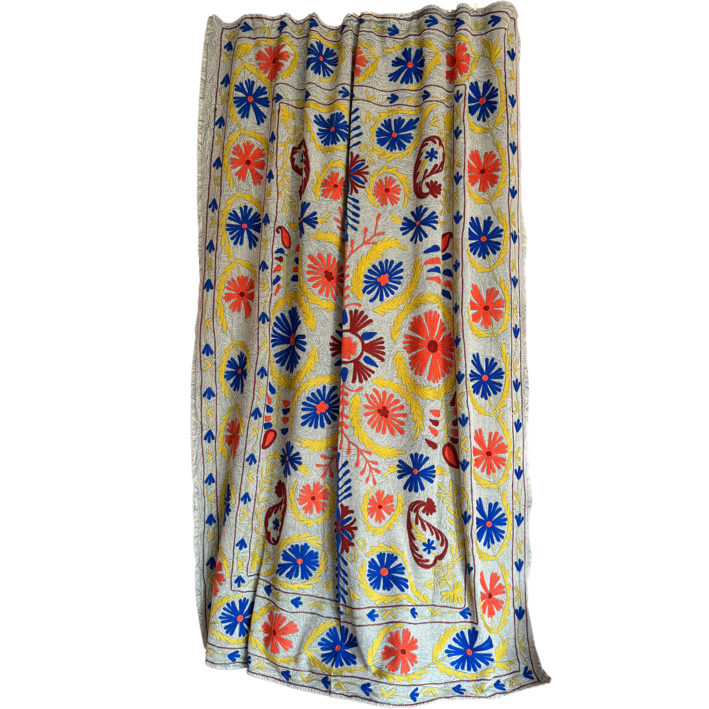 Full front view of grey-ground suzani with coral-red and cobalt-blue floral medallions and mustard-yellow vines