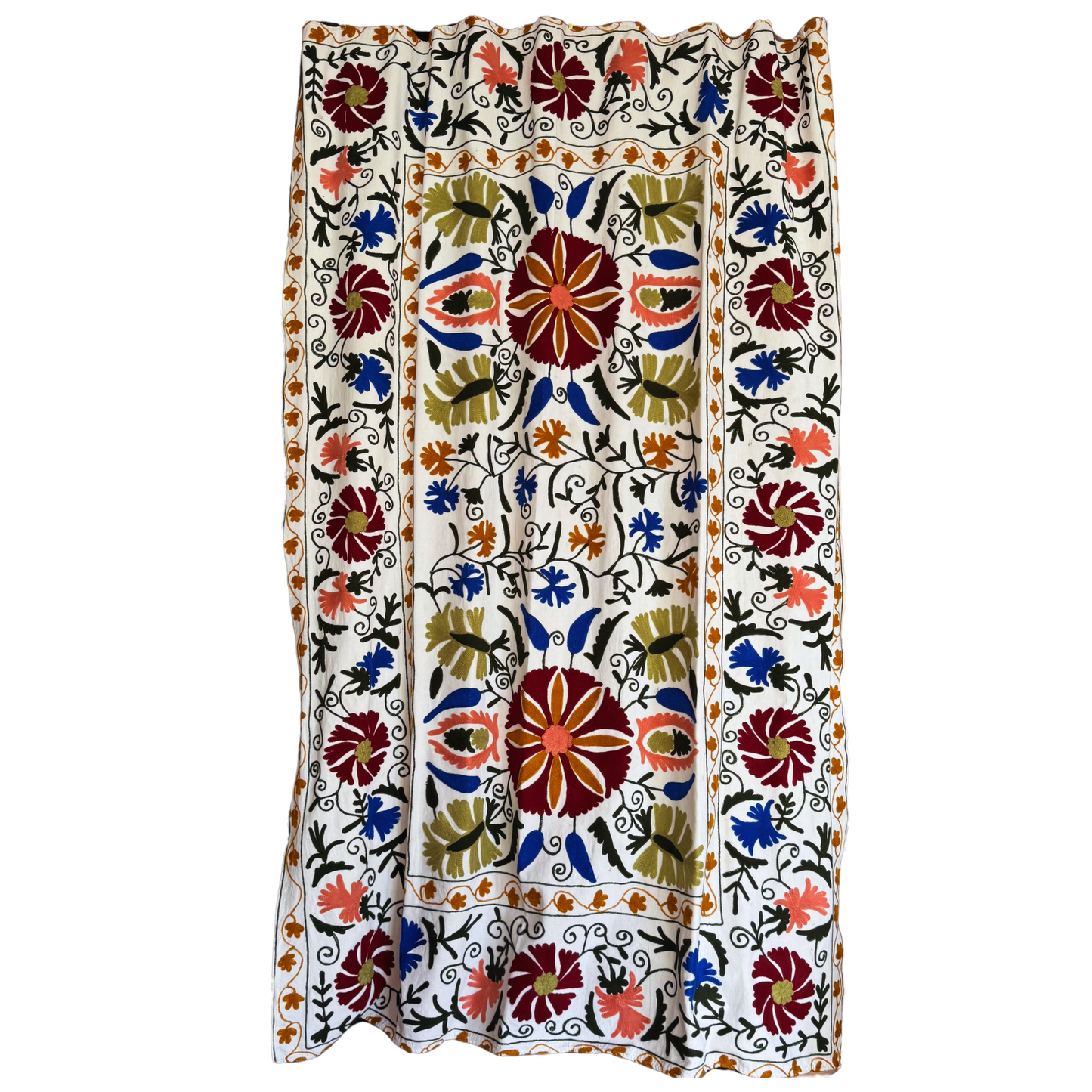 Full view of white cotton Suzani textile with burgundy, cobalt blue, pink and green floral embroidery