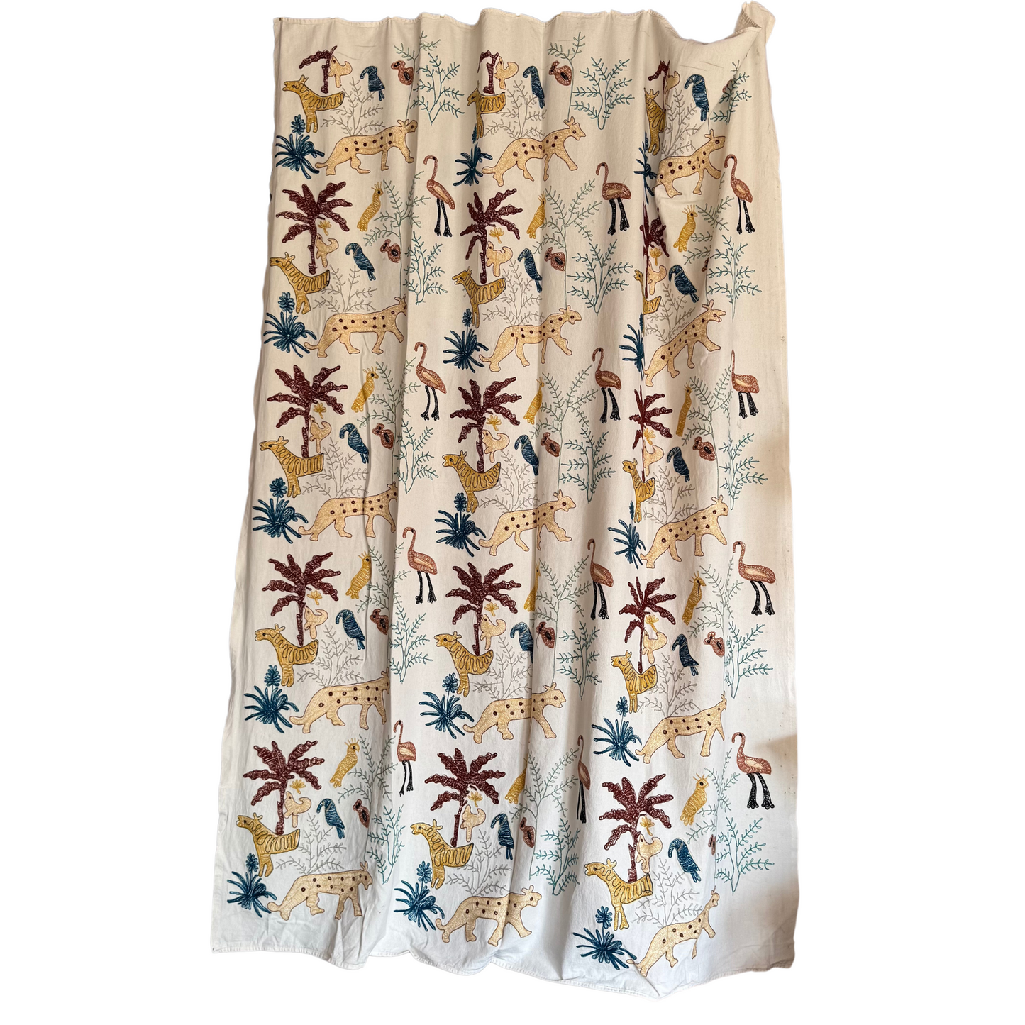 Suzani draped to showcase full embroidery pattern as curtain or wall hanging