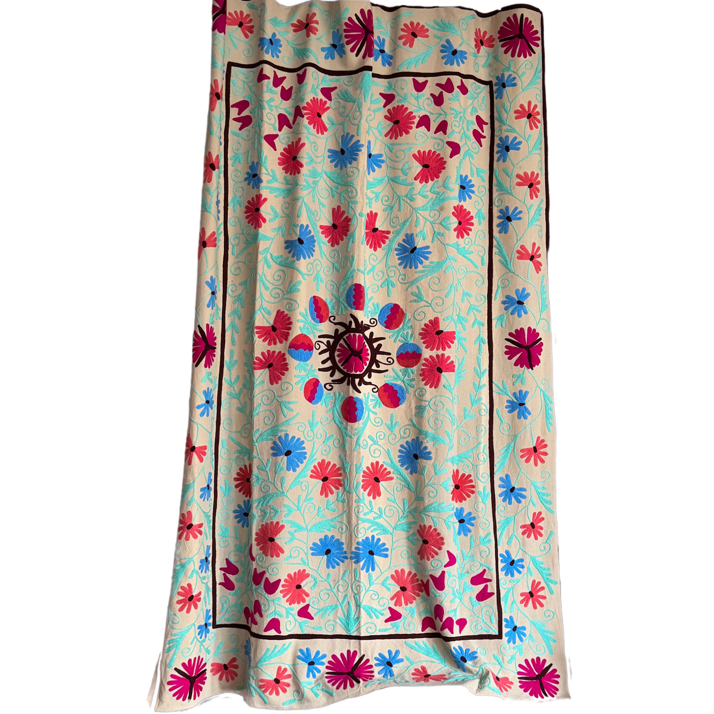 Full view of embroidered Suzani textile in aqua, fuchsia, cobalt, and red on a neutral base