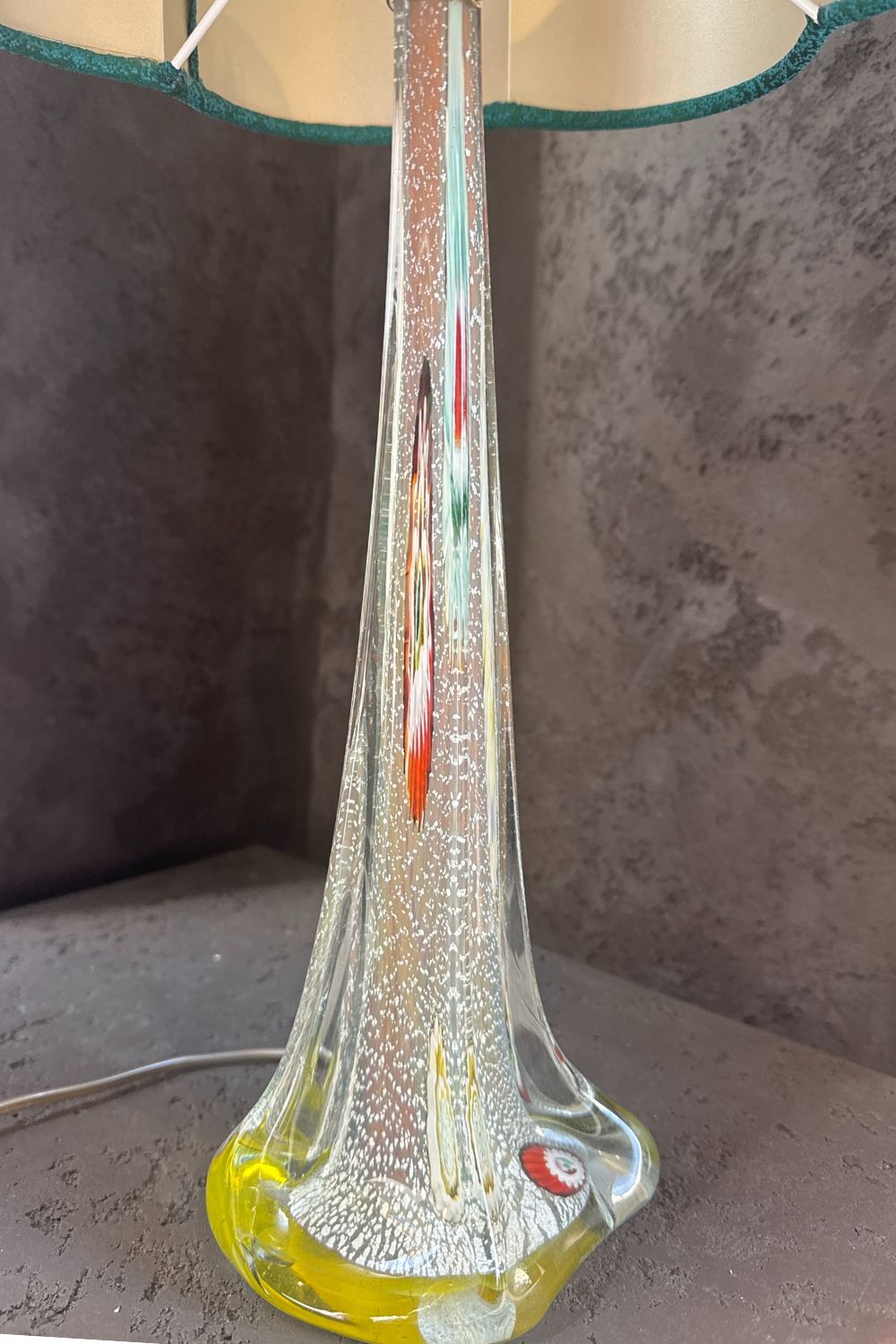 Close-up of the glass lamp base, showcasing the intricate color details and unique shape.