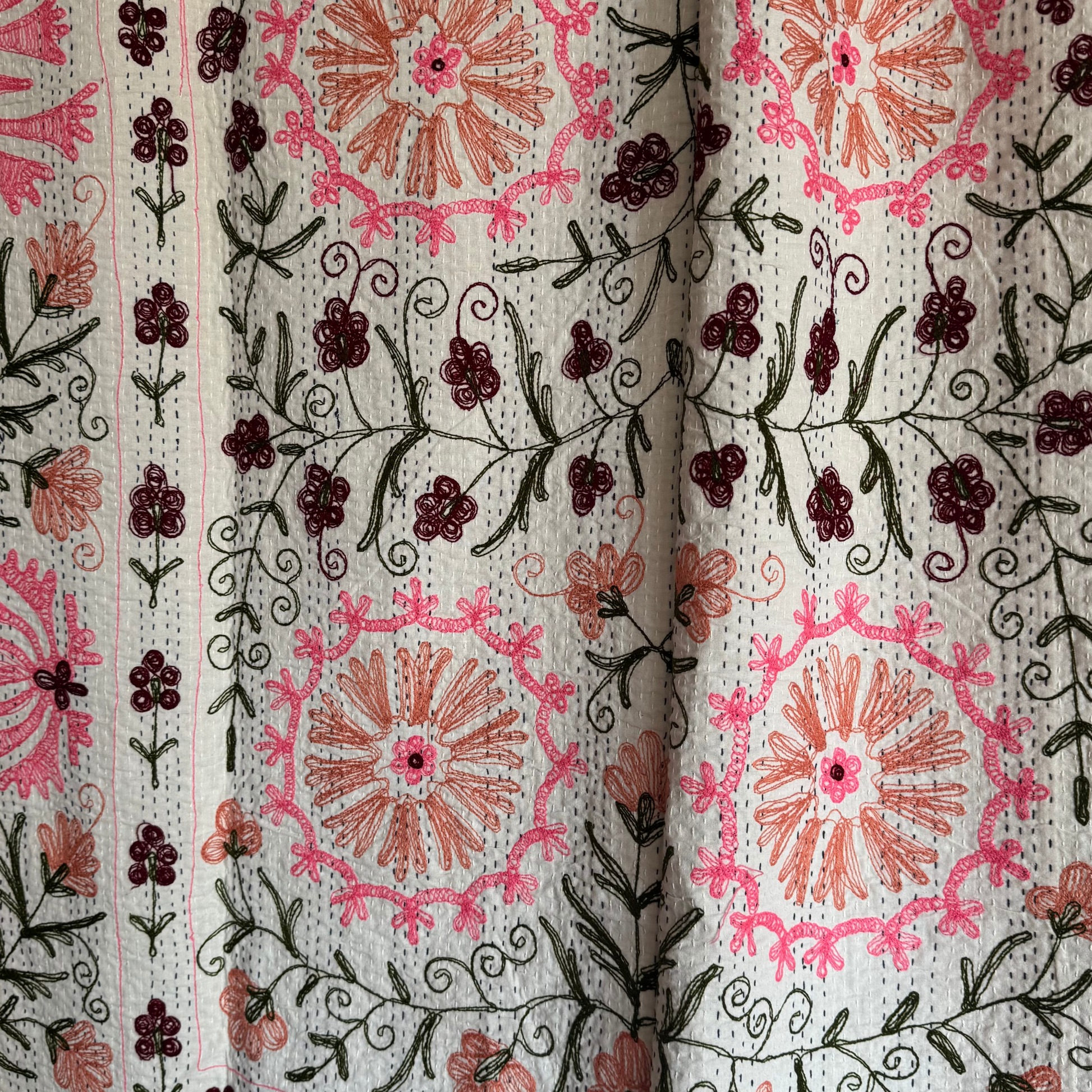 Kantha draped as a curtain, showcasing both embroidered front and stitched reverse