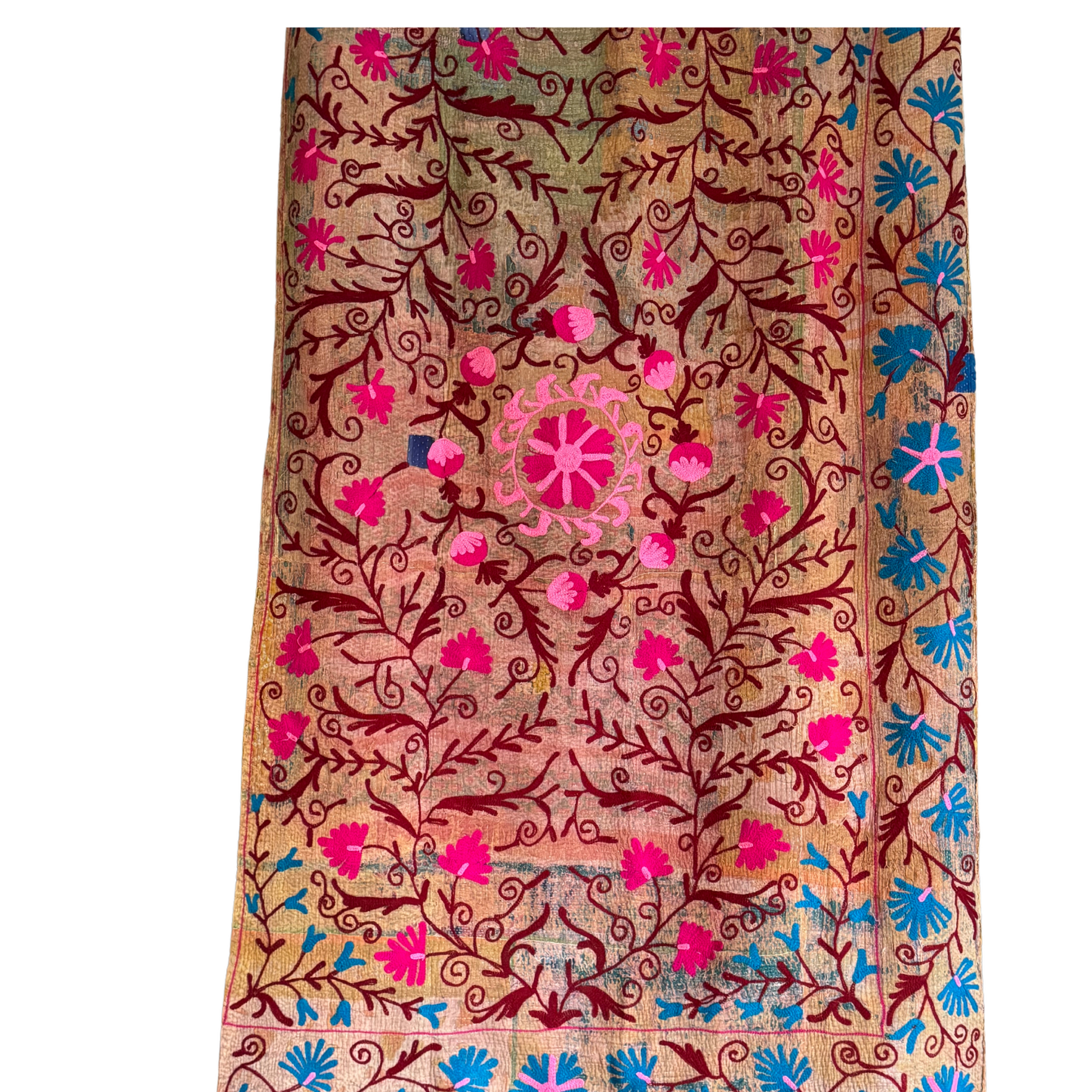 Kantha textile front view with pink floral vines and detailed center medallion on brown patchwork cotton