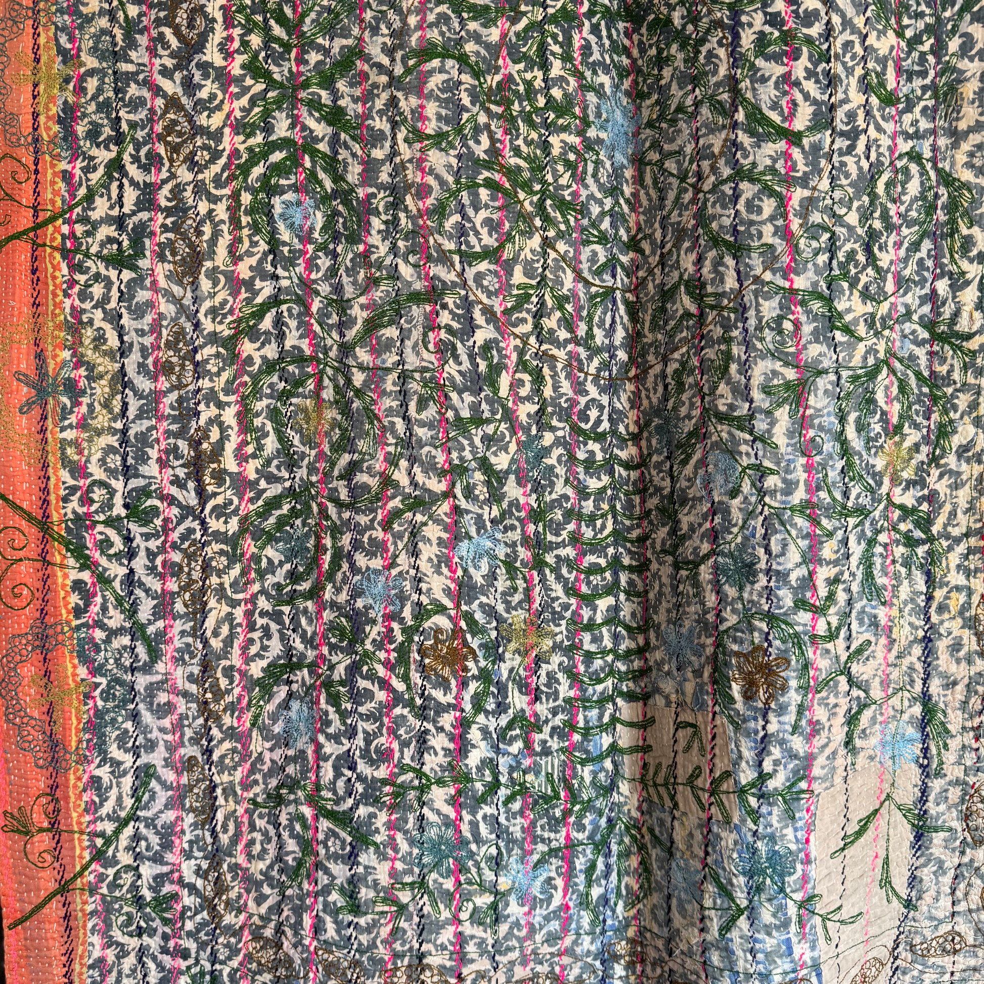 Full view of kantha reverse with dark floral pattern, embroidery, and subtle sari patching