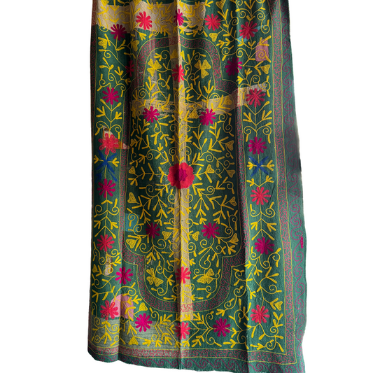 Full view of khanta with grass-green front panel embroidered in yellow and fuchsia florals