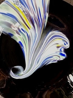 Side angle of a Murano glaze plate, showing its smooth curved shape, elegant finish, and artistic glasswork.