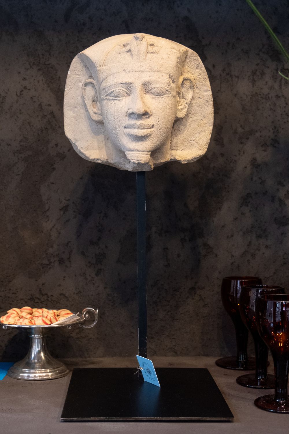 Front view of the stone pharaoh head sculpture with detailed facial features and a regal headdress.
